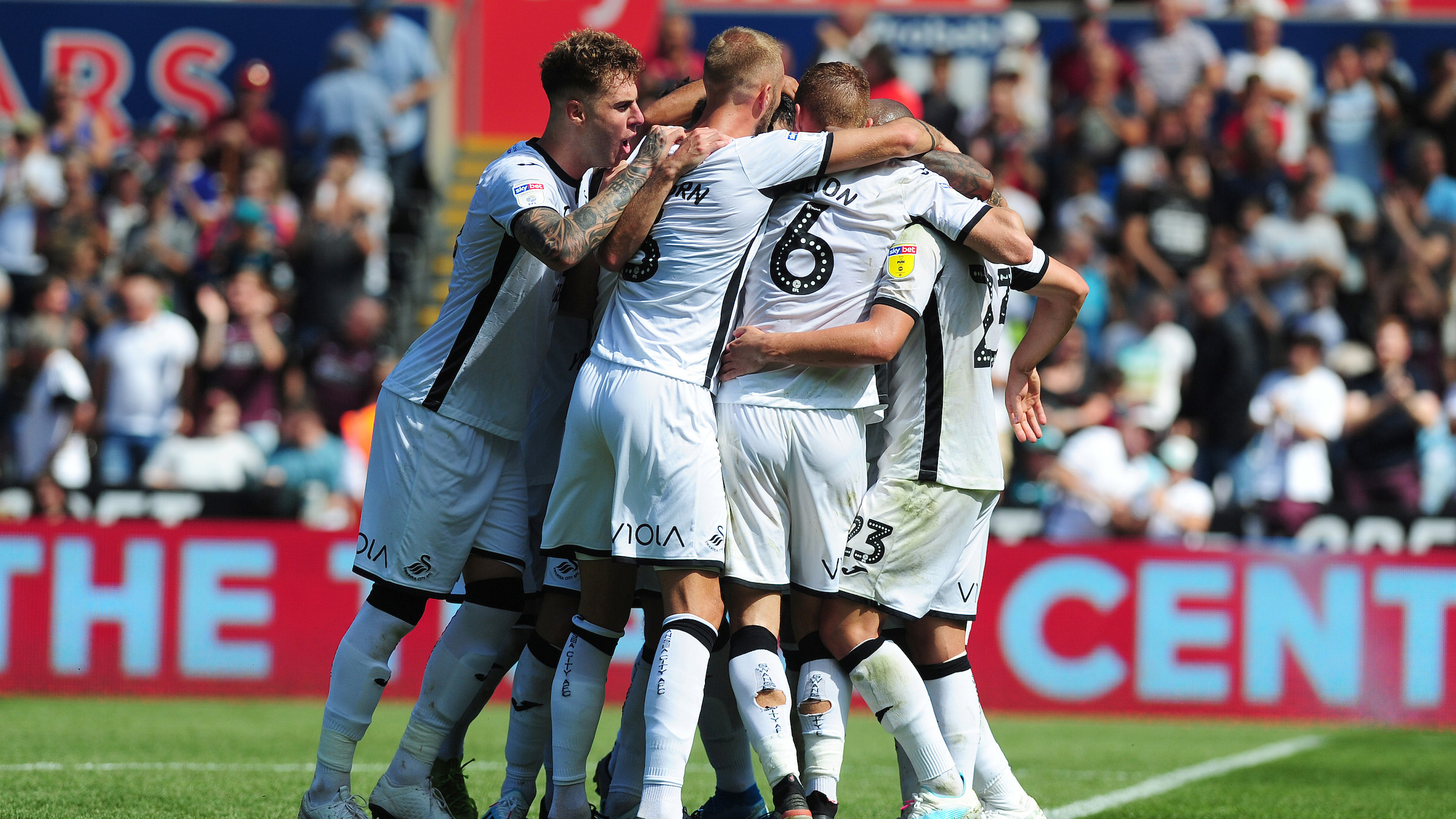 The Swans squad celebrate a goal