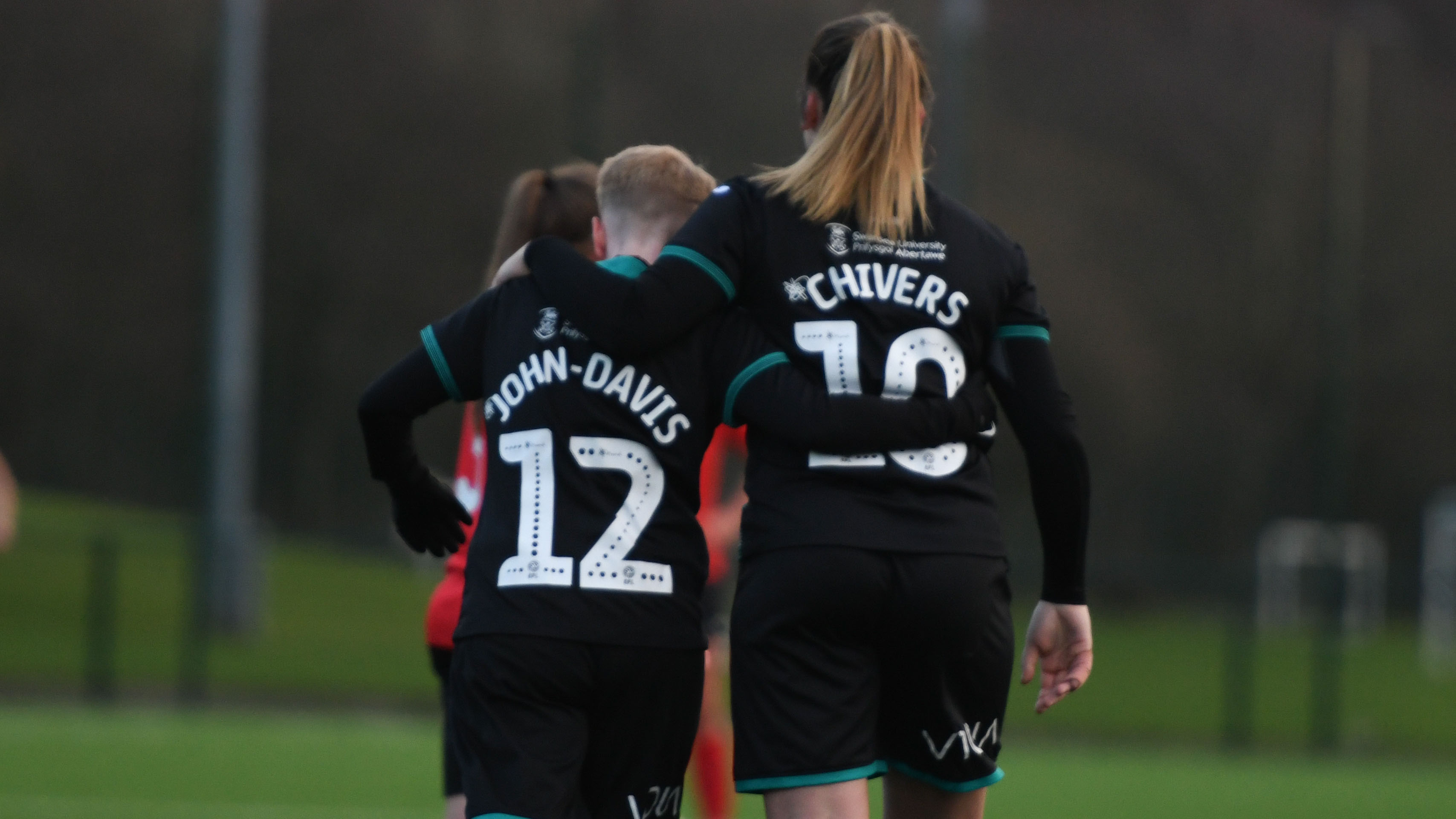 Stacey John-Davis and Chloe Chivers celebrate a goal.