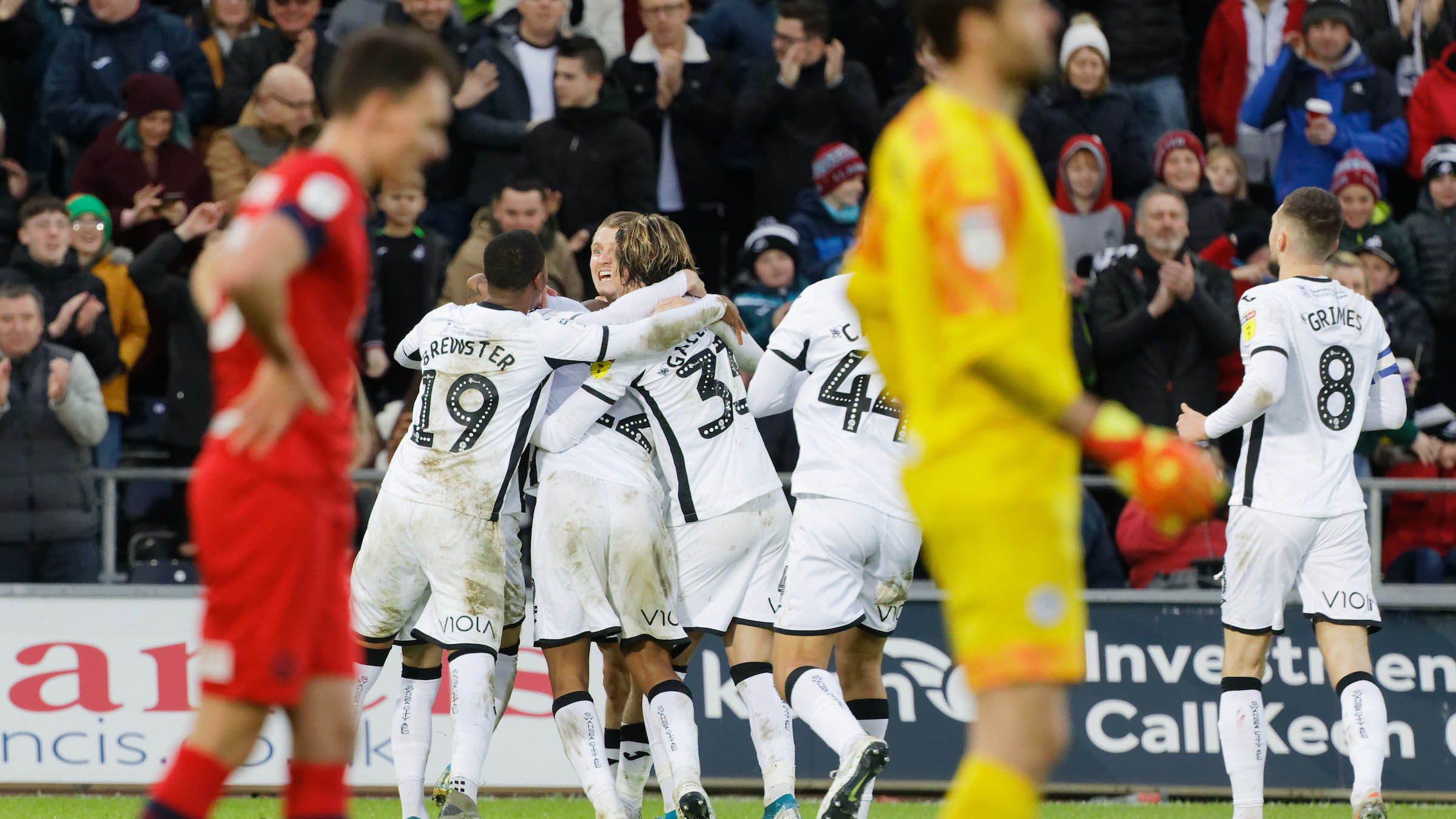 The Swans squad celebrate a goal