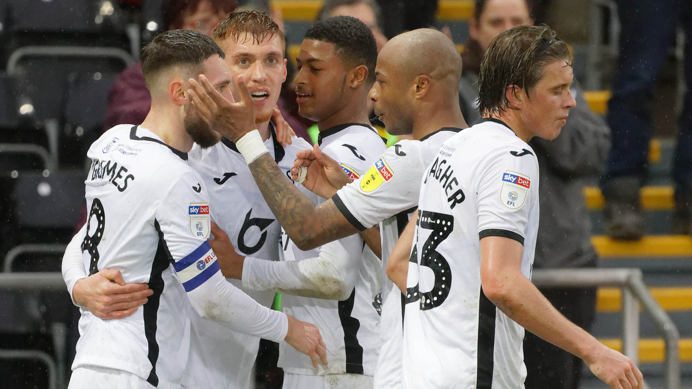 The Swans squad celebrate a goal