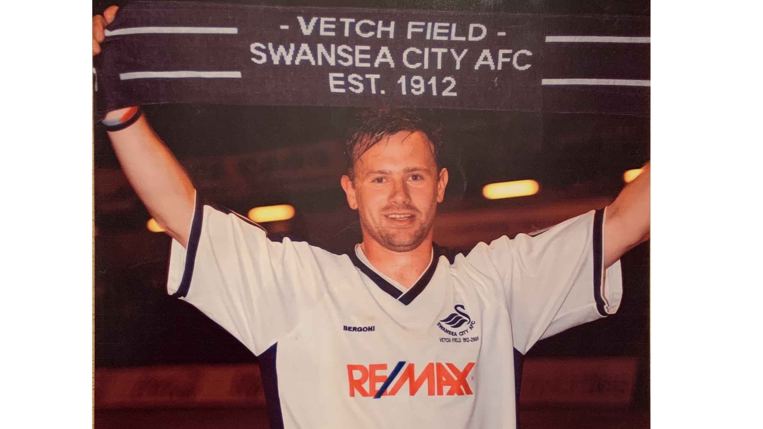 Goalscorer Kristian O'Leary holds aloft a Swansea City scarf after the 1-0 win over Oxford United in the final floodlit game at the Vetch Field. Photo courtesy of Kristian O'Leary