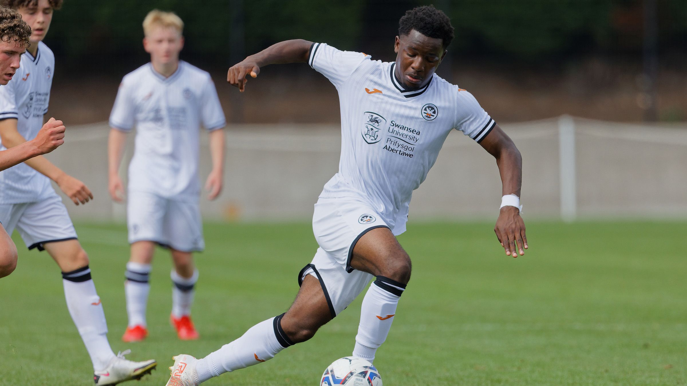 Swansea, Wales. 4 February 2023. Oliver Evans of Millwall under pressure  from Zane Myers of Swansea City during the Professional Development League  game between Swansea City Under 18 and Millwall Under 18