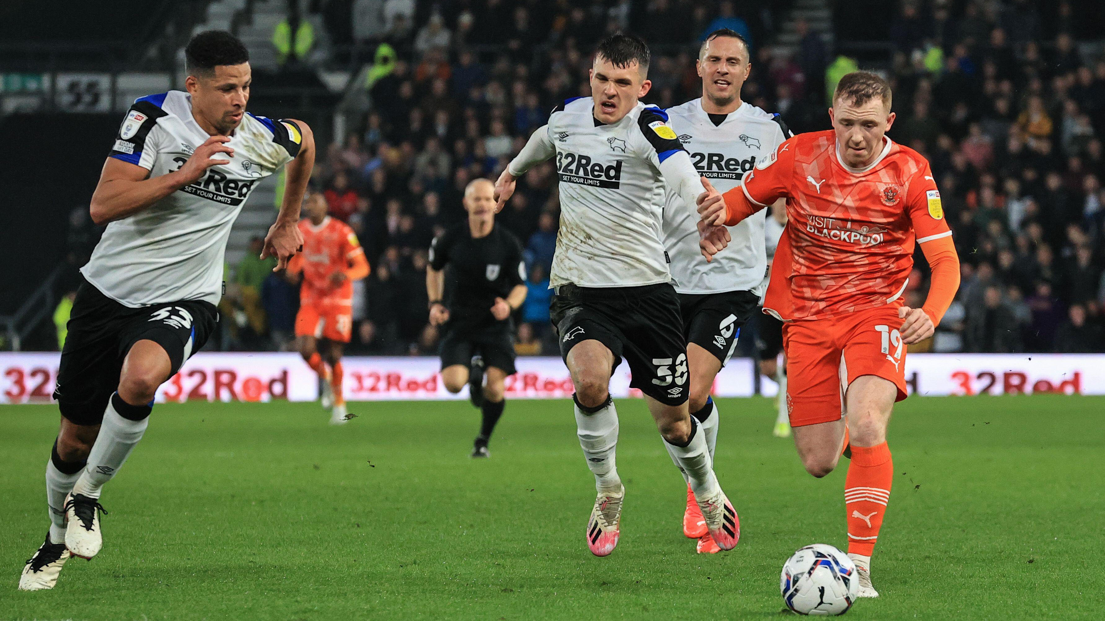 Blackpool forward Shayne Lavery runs away from Derby County players