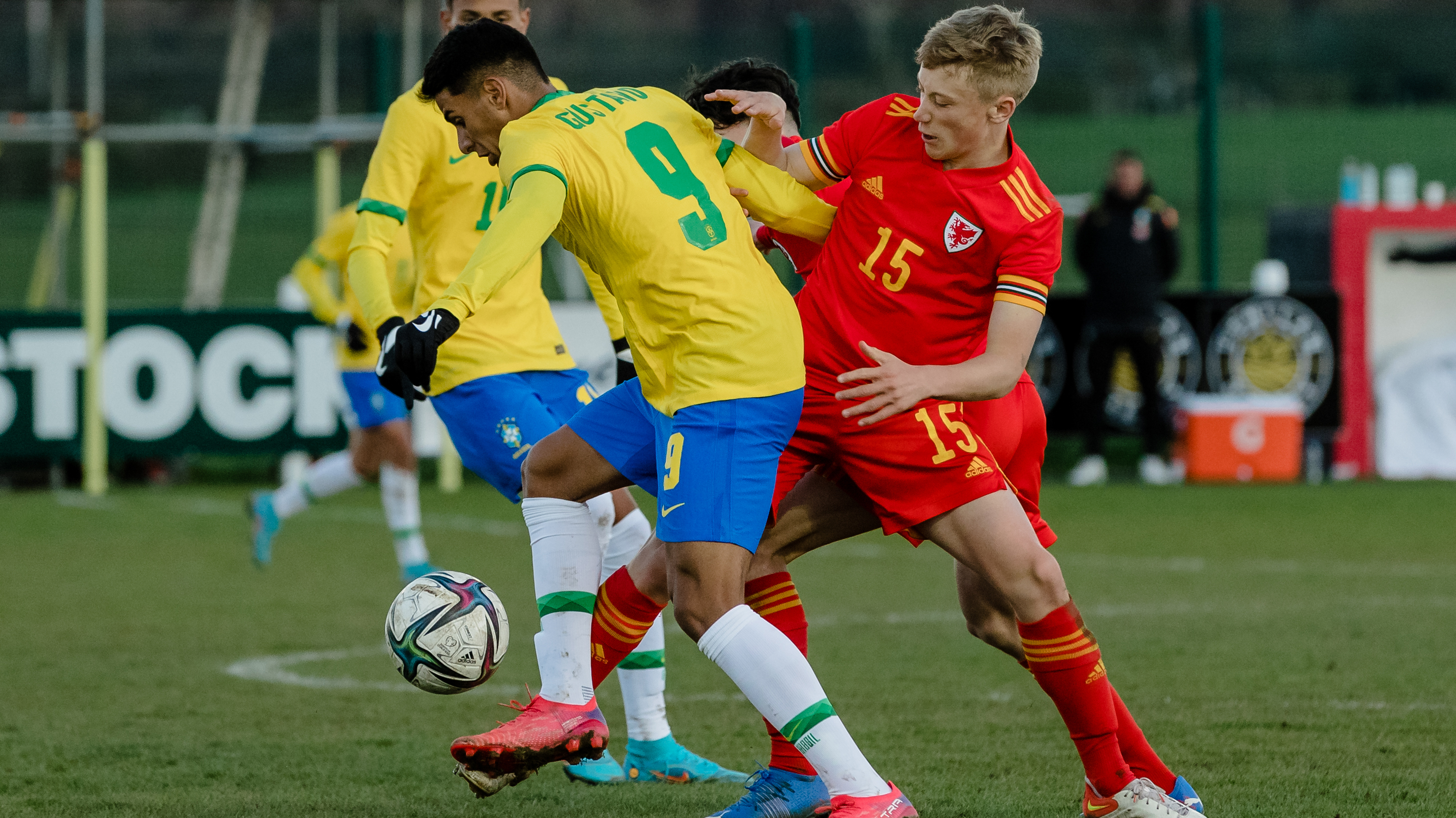 Jacob Cook of Wales and Swansea tackles Brazil player