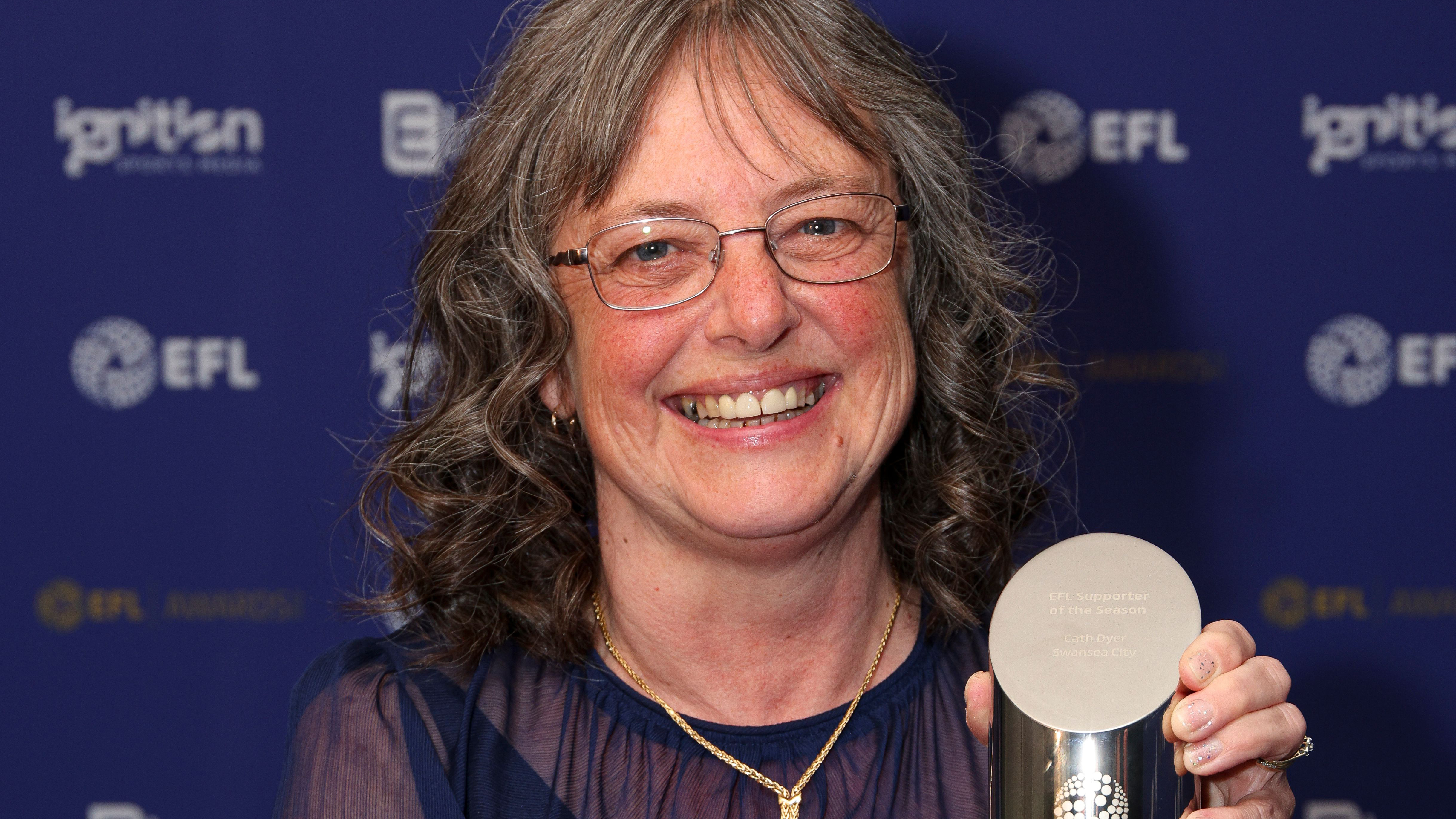 Swansea fan Cath holds EFL Supporter of the Season trophy