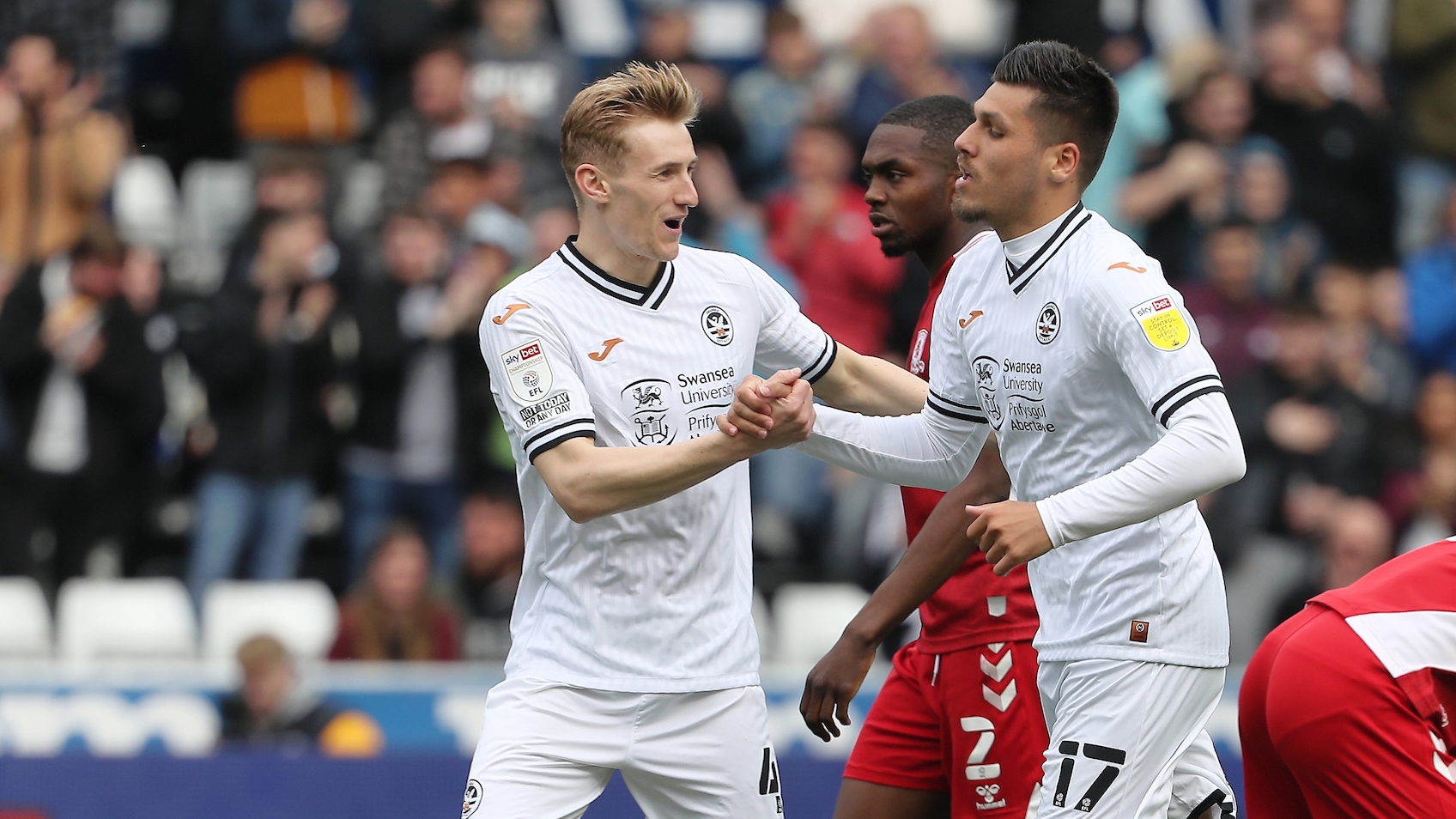 Flynn Downes and Joel Piroe celebrate