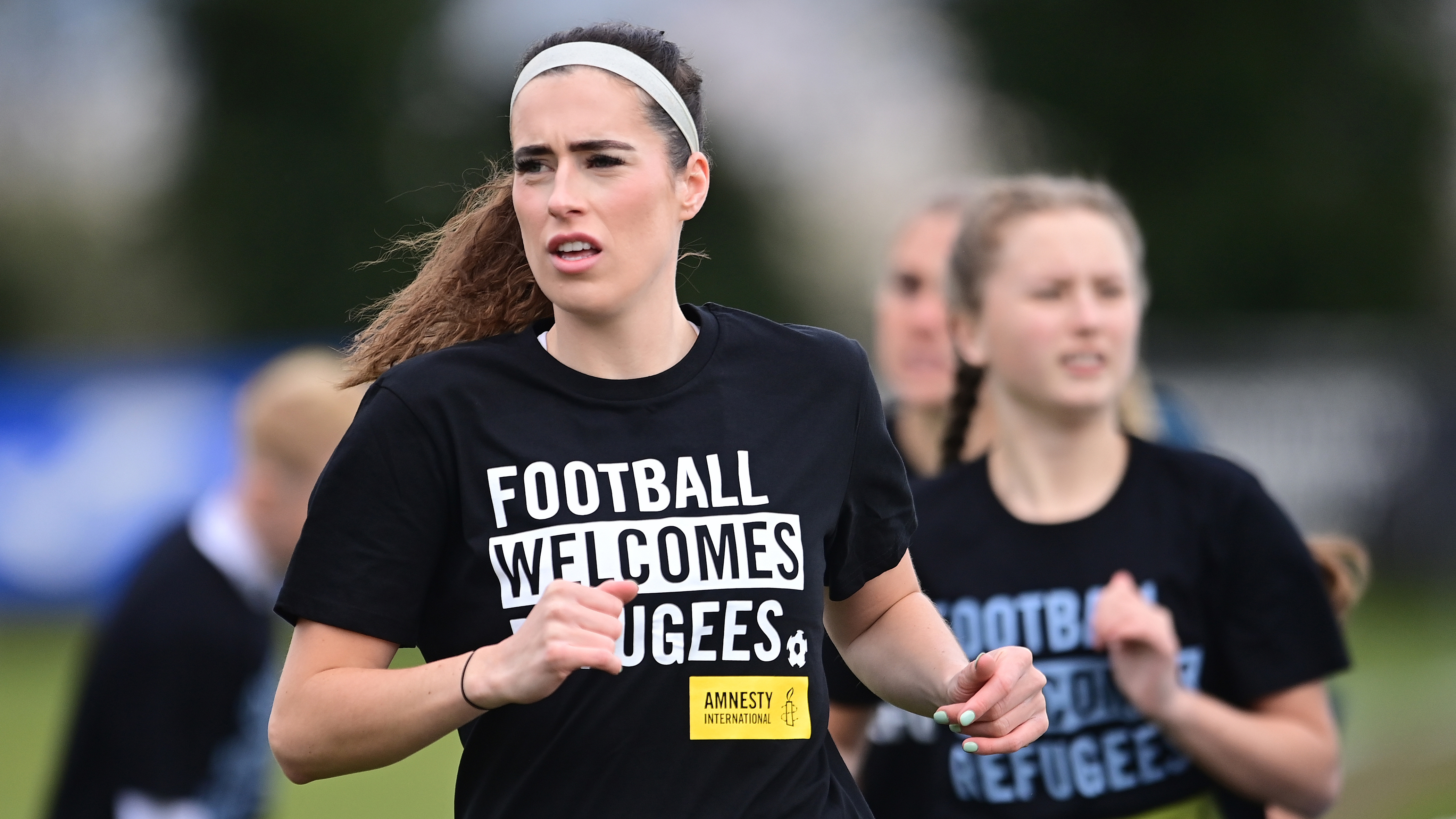 Swansea City ladies warm up in football welcomes shirts