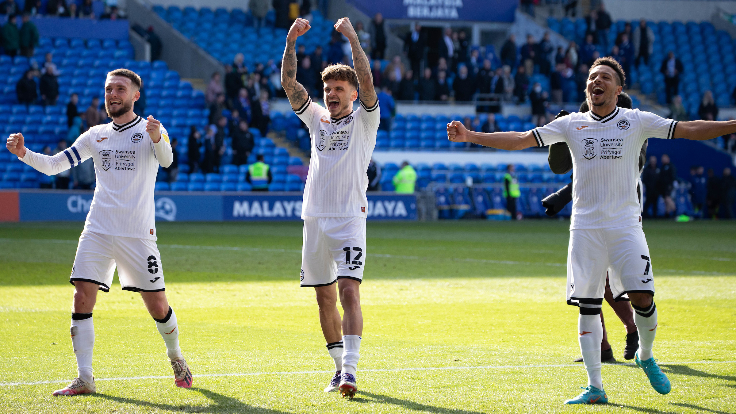 Matt Grimes, Jamie Paterson and Korey Smith celebrate