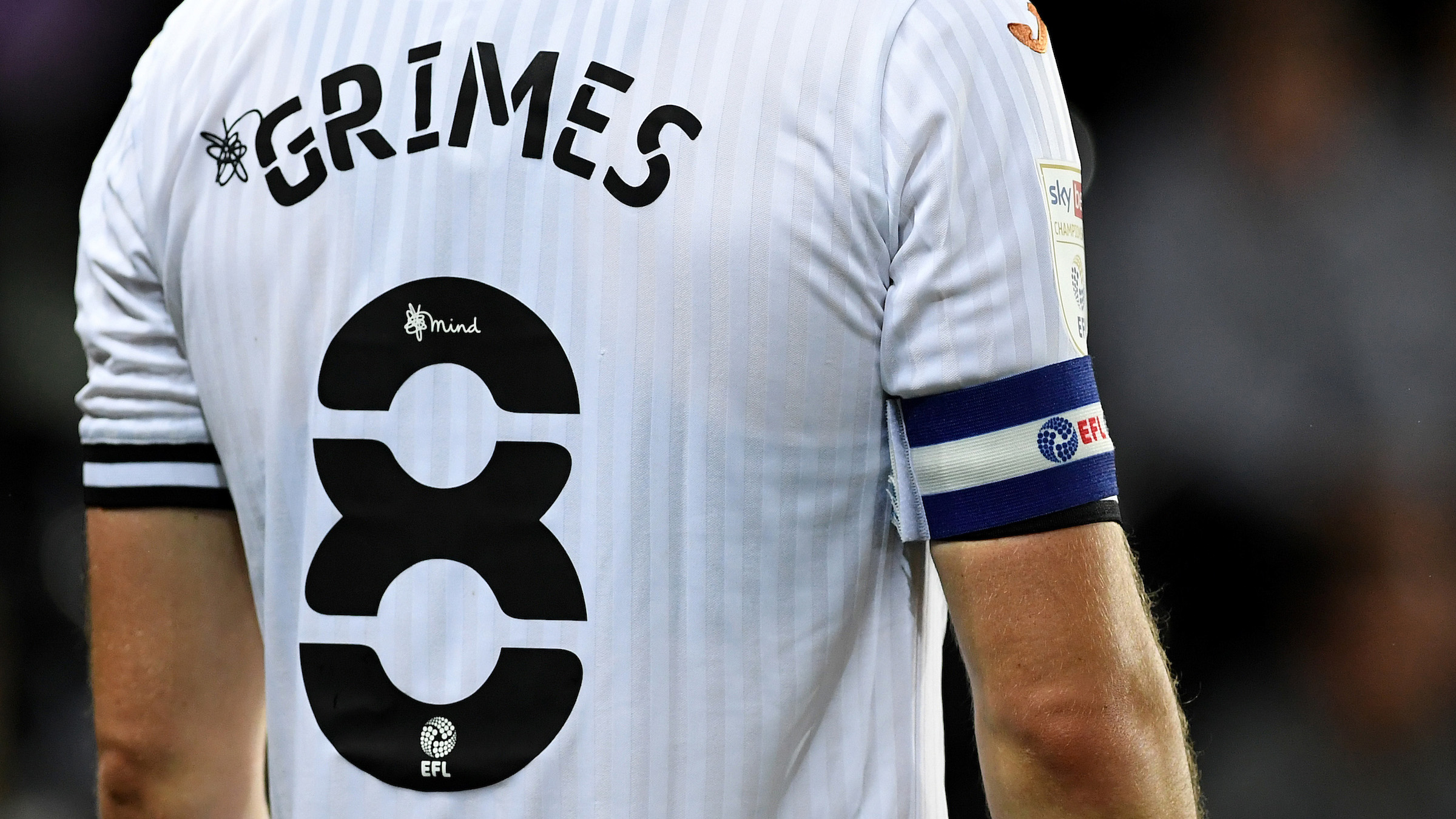 The back of Matt Grimes' shirt showing name, number and captain's armband