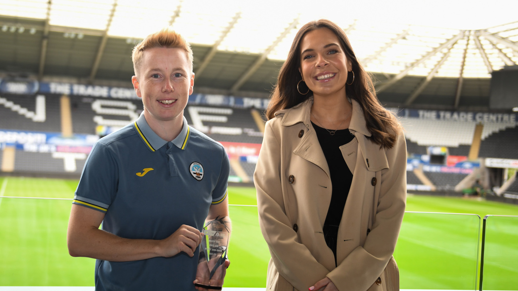 Stacey John-Davies holds top scorer trophy next to tv presenter Sioned Dafydd