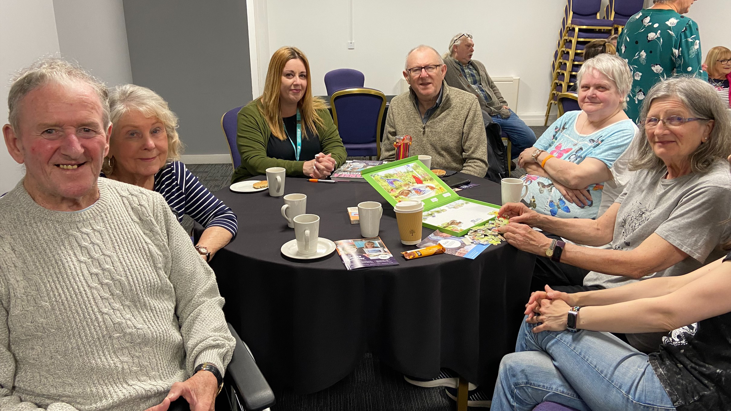 People at the dementia coffee morning pose for a photo