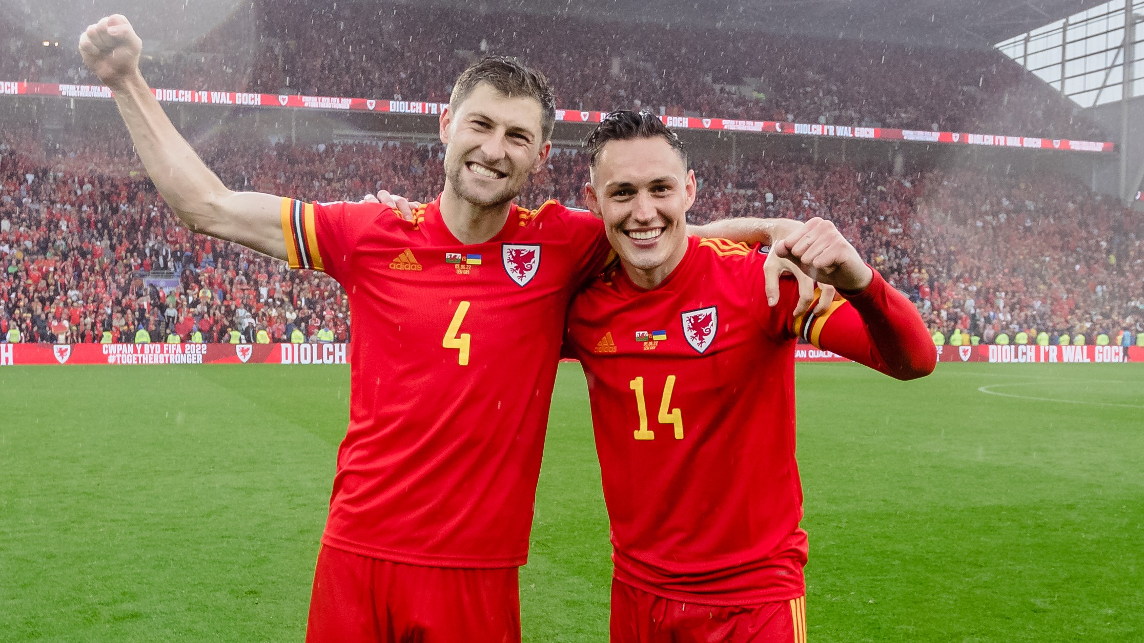 Ben Davies and Connor Roberts stand together celebrating Wales qualifying for the world cup