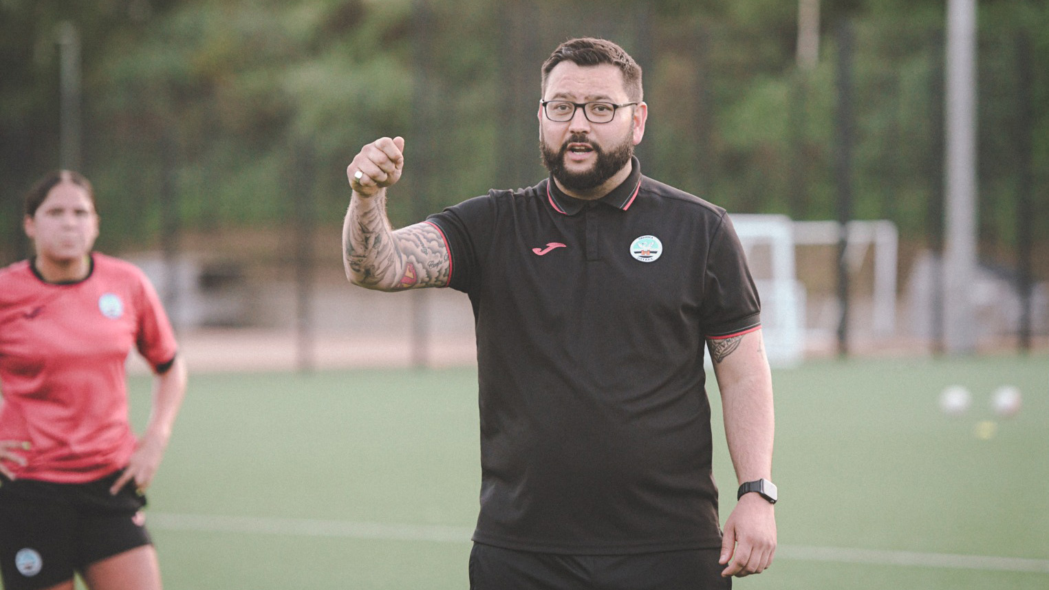 Swansea City Ladies head coach Jon Beale provides instructions for players at training