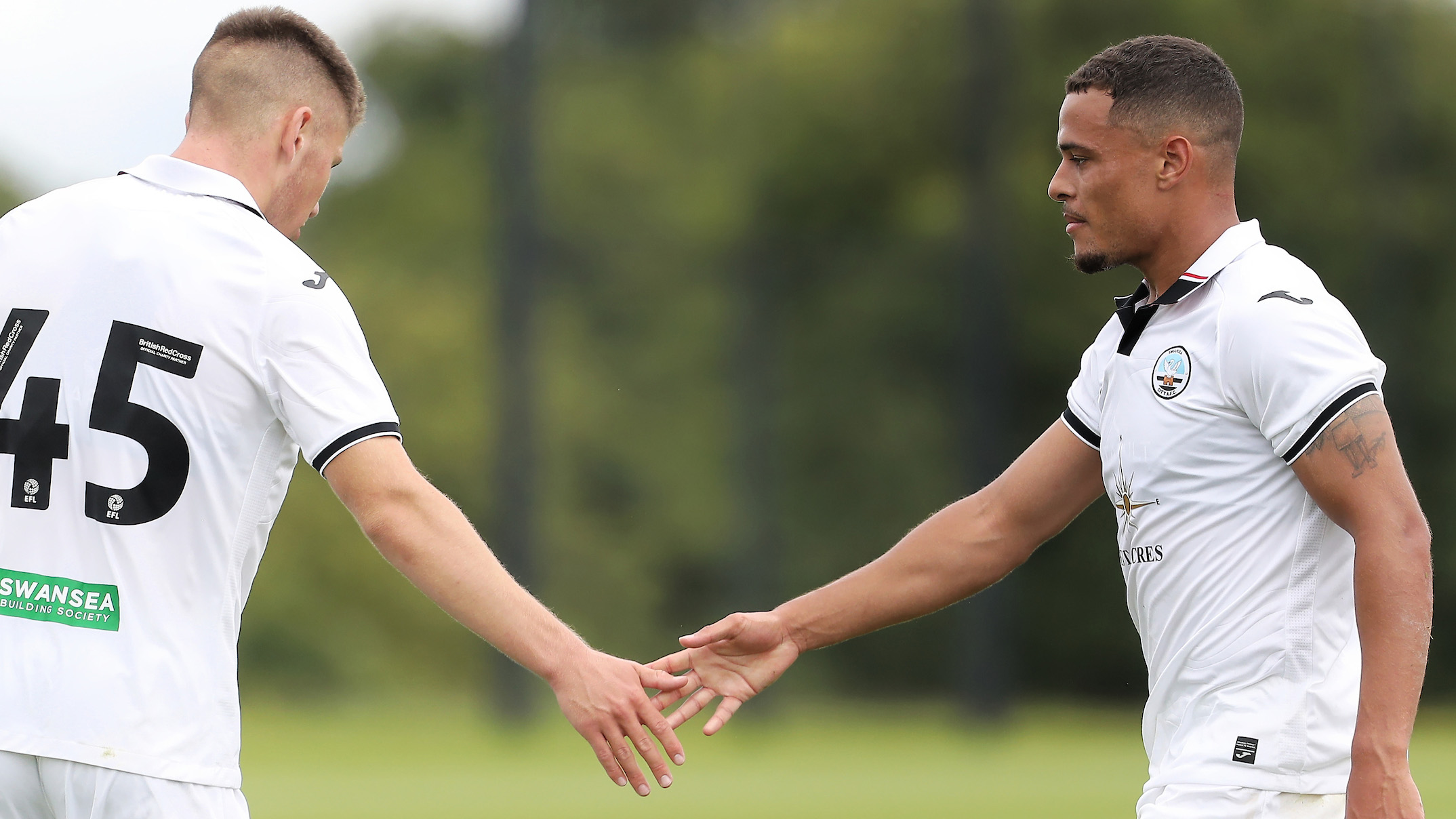 Joel Latibeaudiere high-fives Cameron Congreve after goal against Colchester United in pre-season friendly