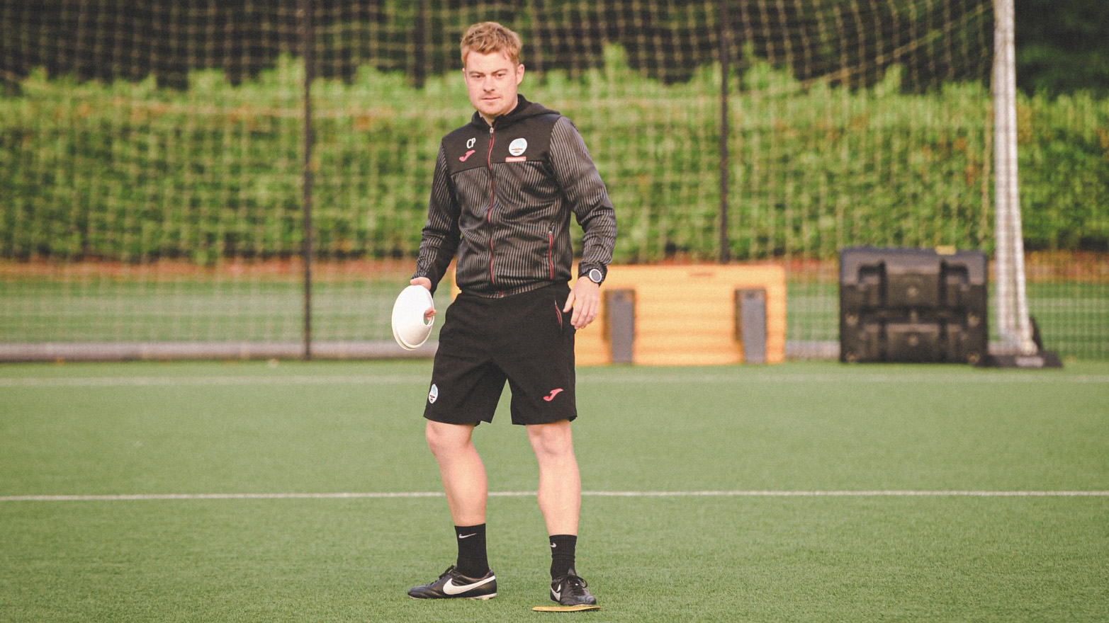 Ceri Phillips holds a football during a Swansea City Ladies coaching session 