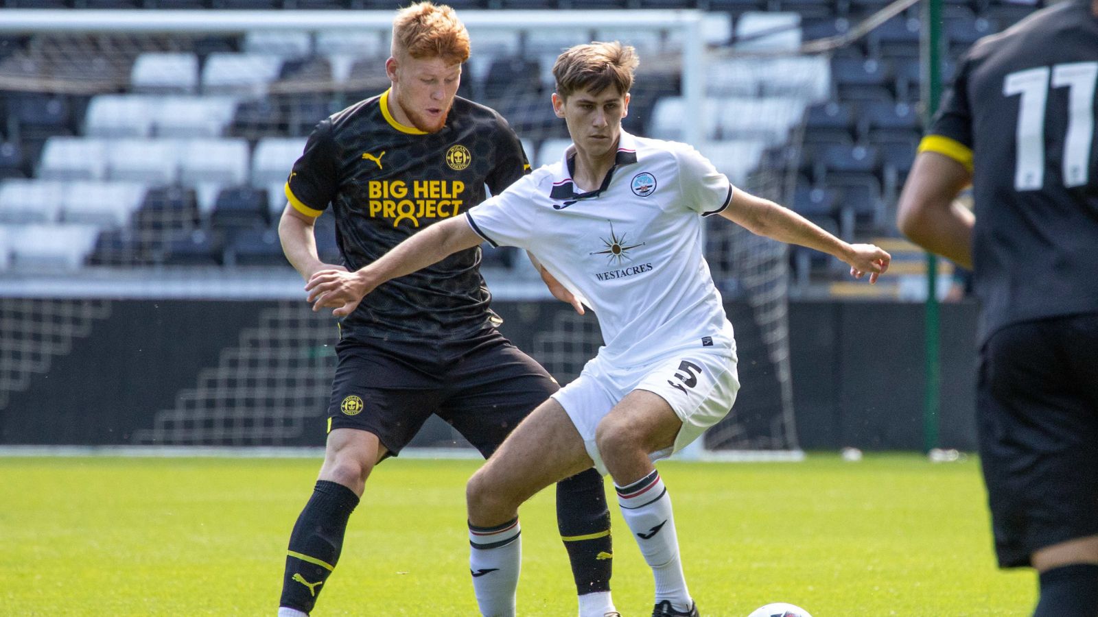 Swansea, Wales. 4 February 2023. Geoffroy Bony of Swansea City battles for  possession with Kyron Horsley-McKay of Millwall during the Professional  Development League game between Swansea City Under 18 and Millwall Under