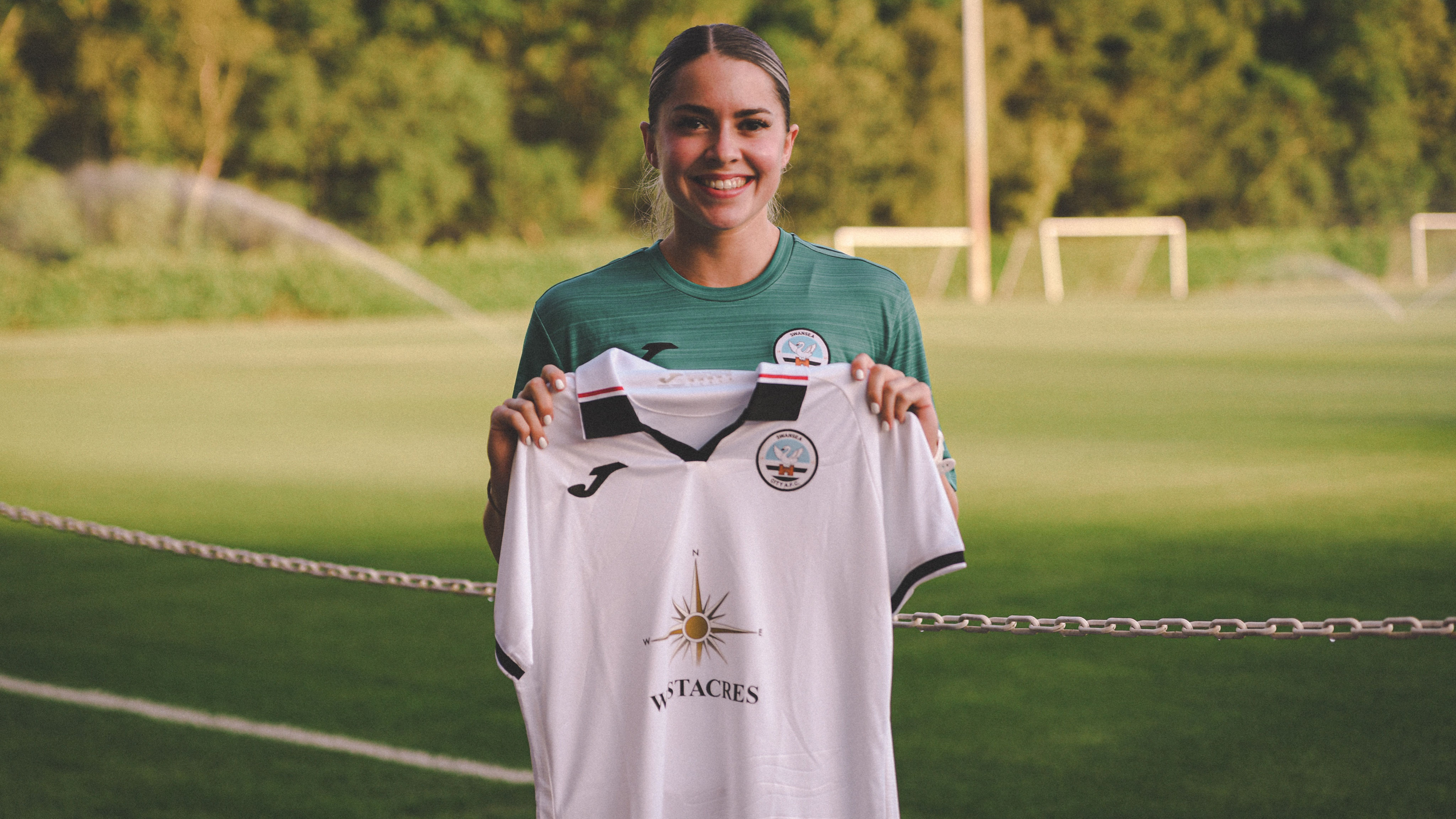 Emily Freeman holds Swansea City shirt