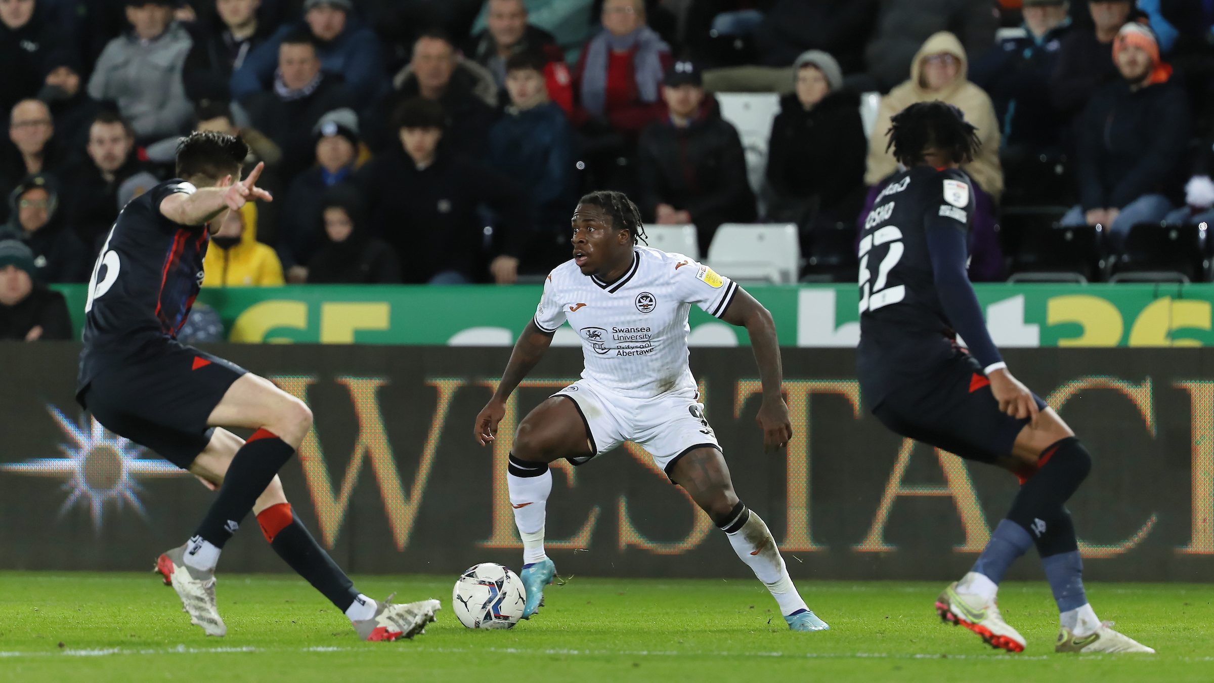 Obafemi takes on two Luton Town players 