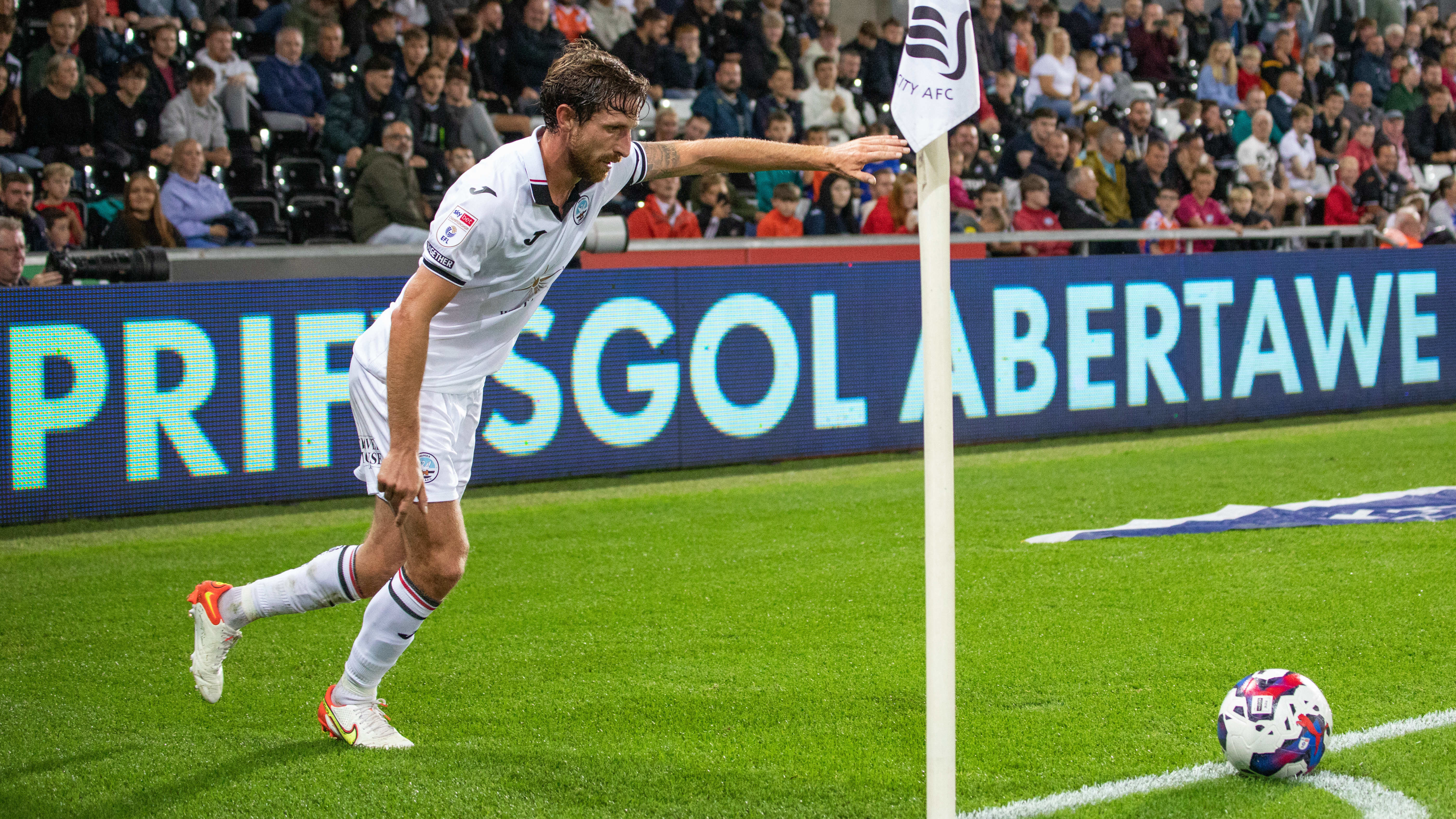 Joe Allen takes a corner against Millwall