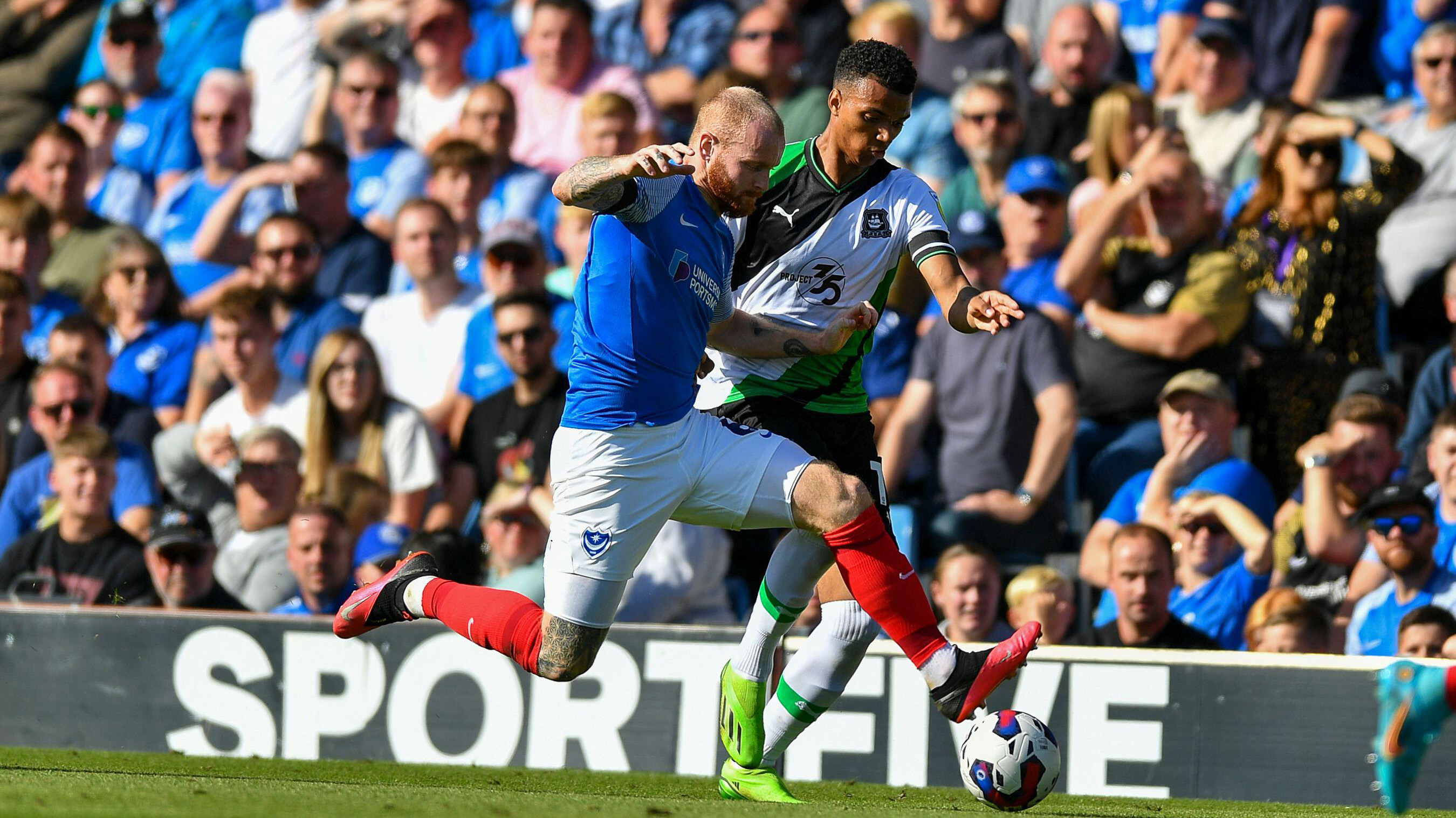 Morgan Whittaker challenging for the ball against Portsmouth
