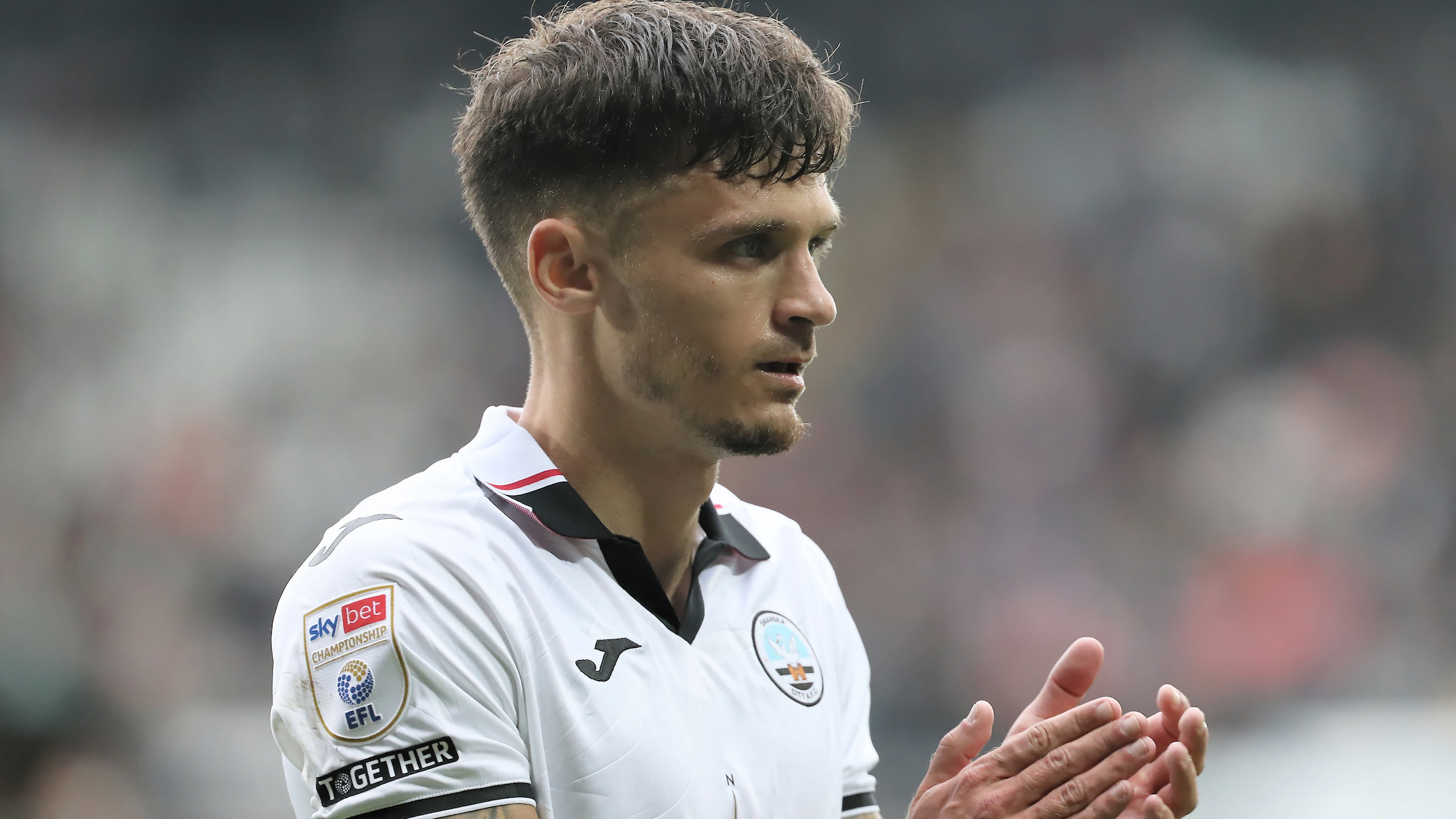 Jamie Paterson applauds the fans