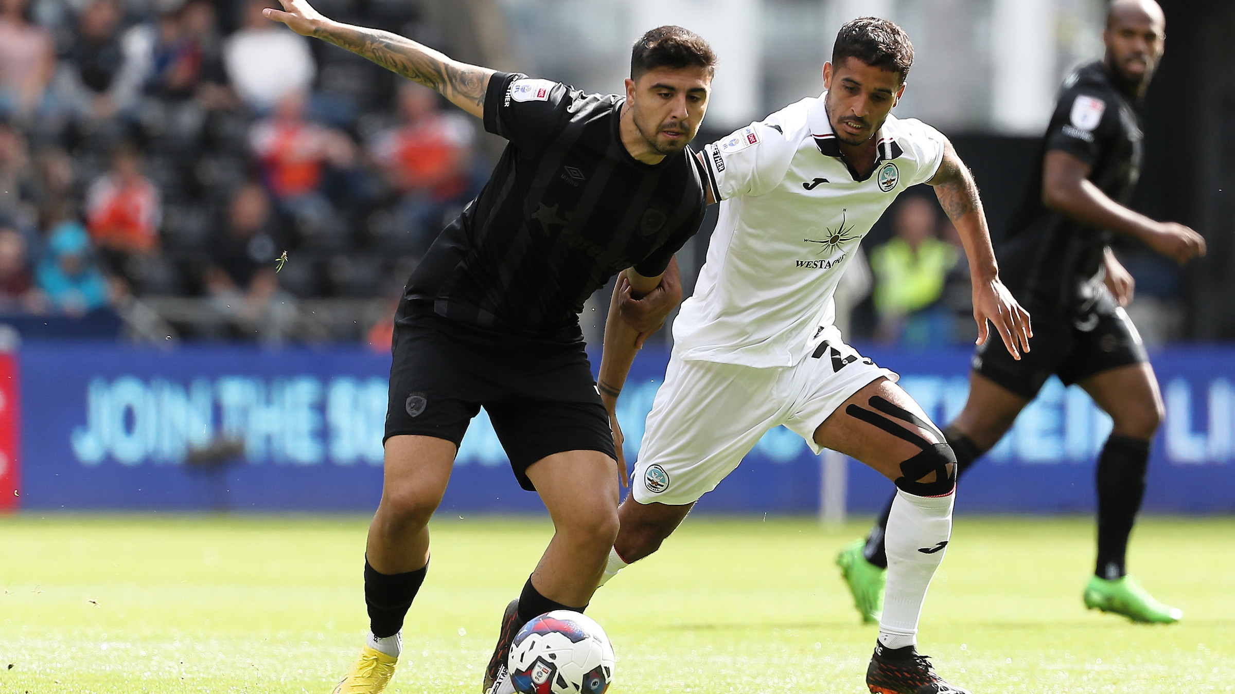 Kyle Naughton makes a challenge v Hull City