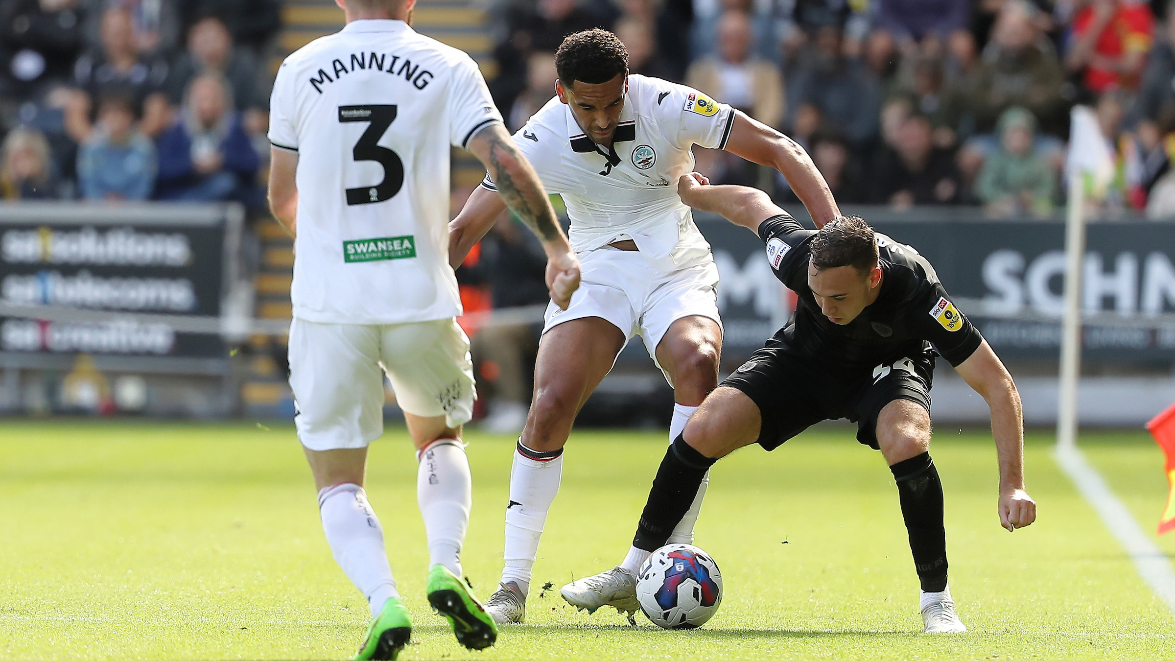 Ben Cabango holds off a challenge against Hull City