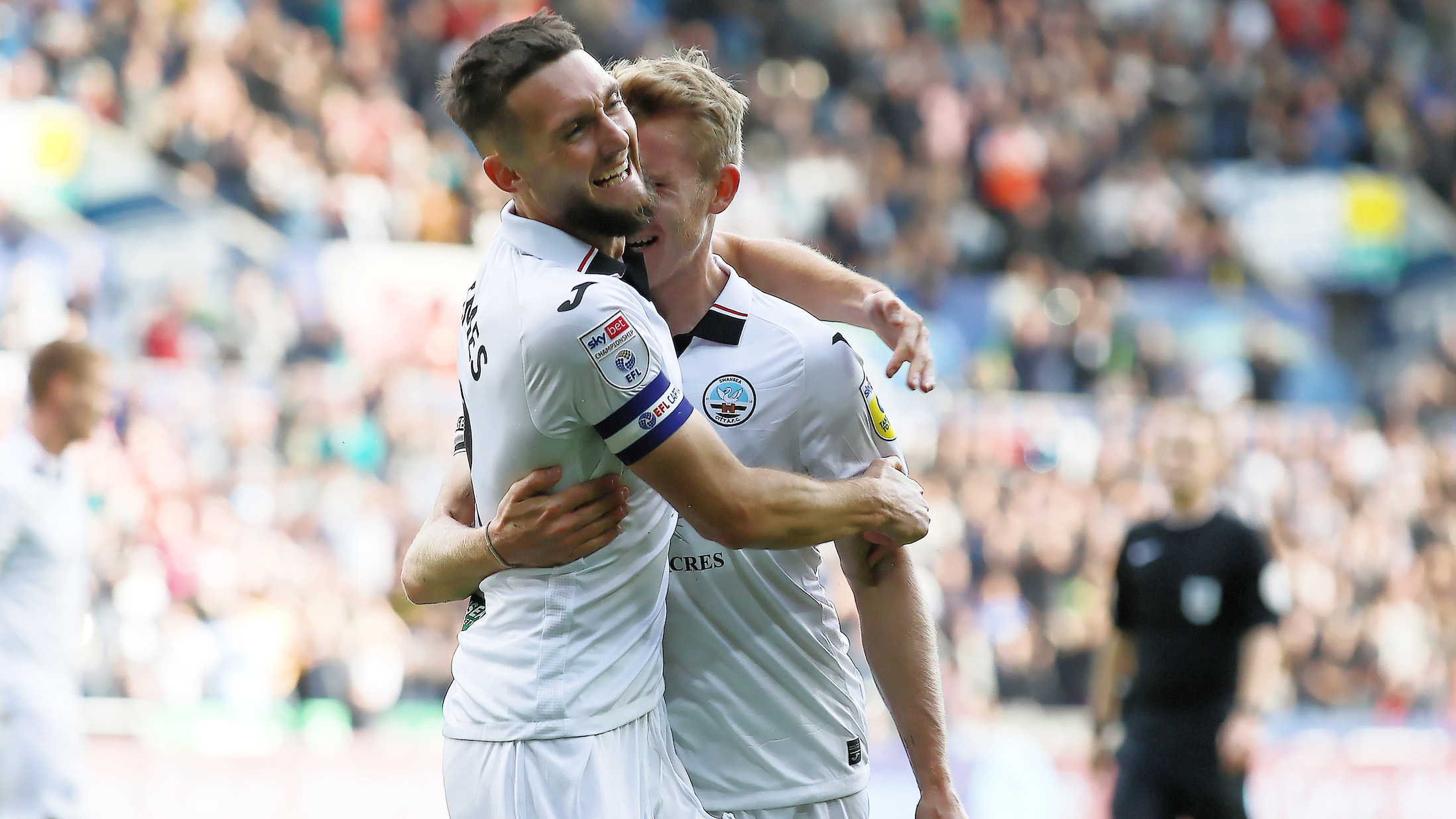 Matt Grimes and Ollie Cooper hug