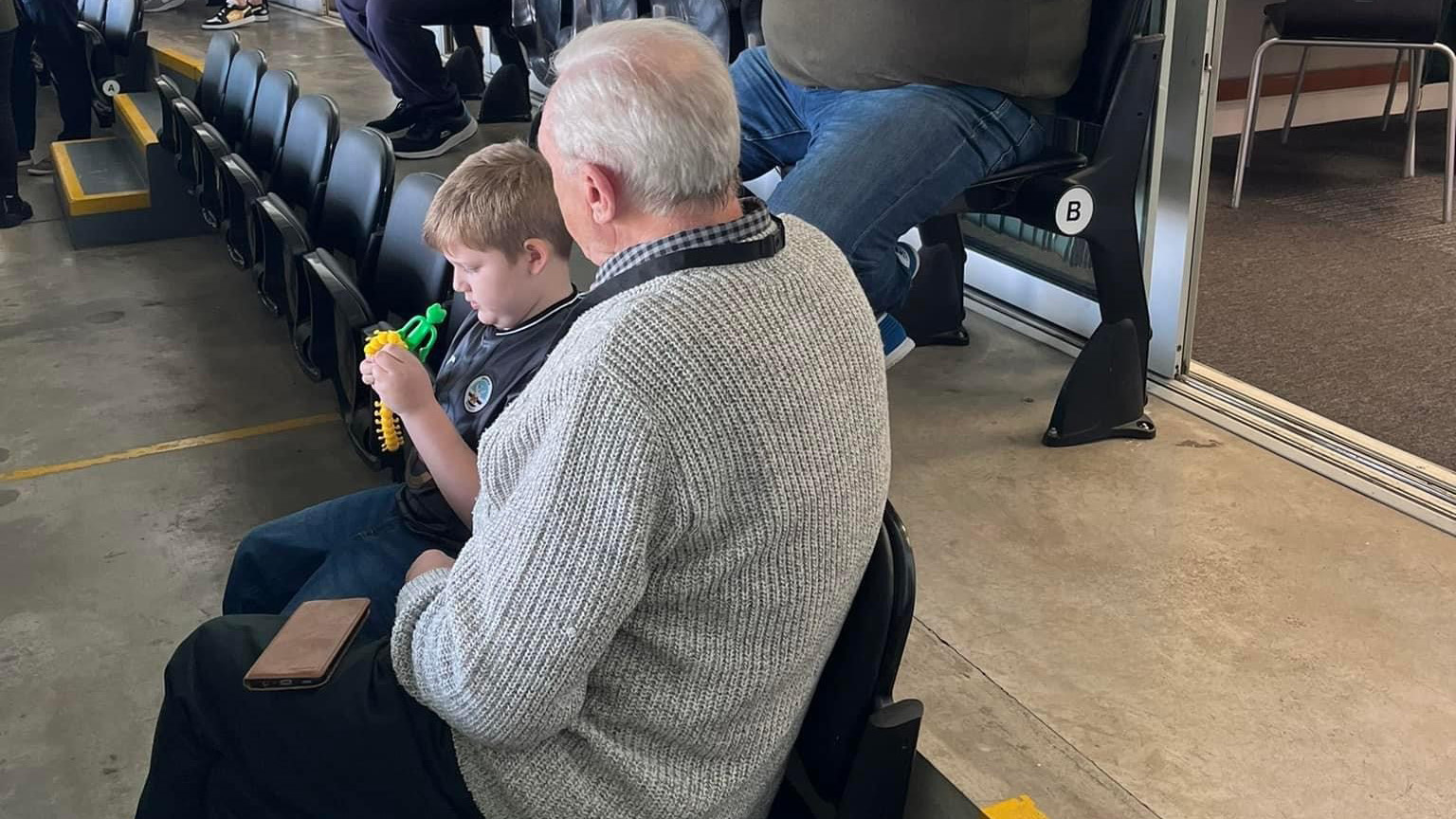 Ron and great grandson Harrison watch football from the sensory room