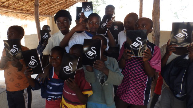 Children in Mkushi with Swansea City notebooks