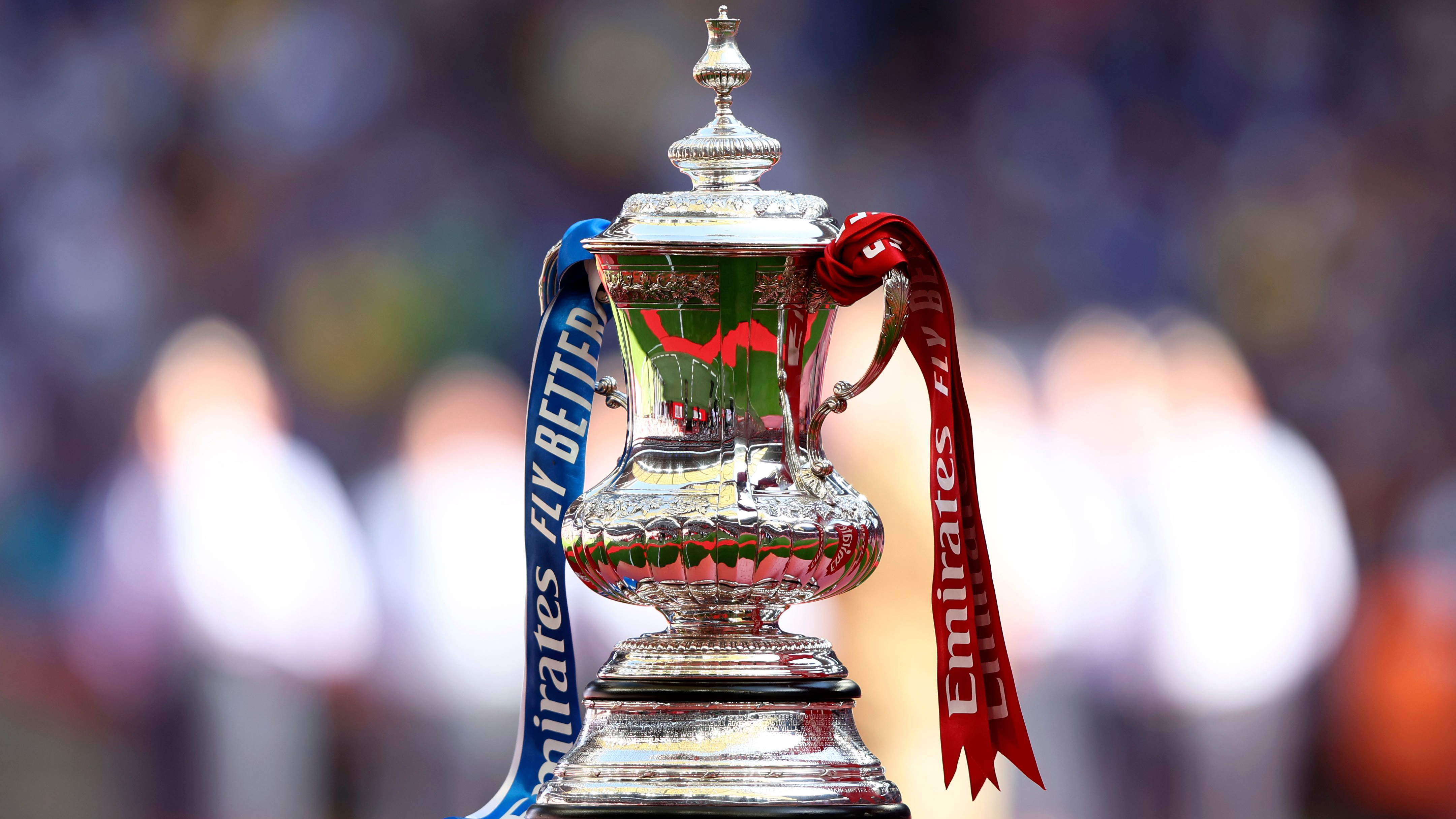 Image of the FA Cup with blue and red ribbons