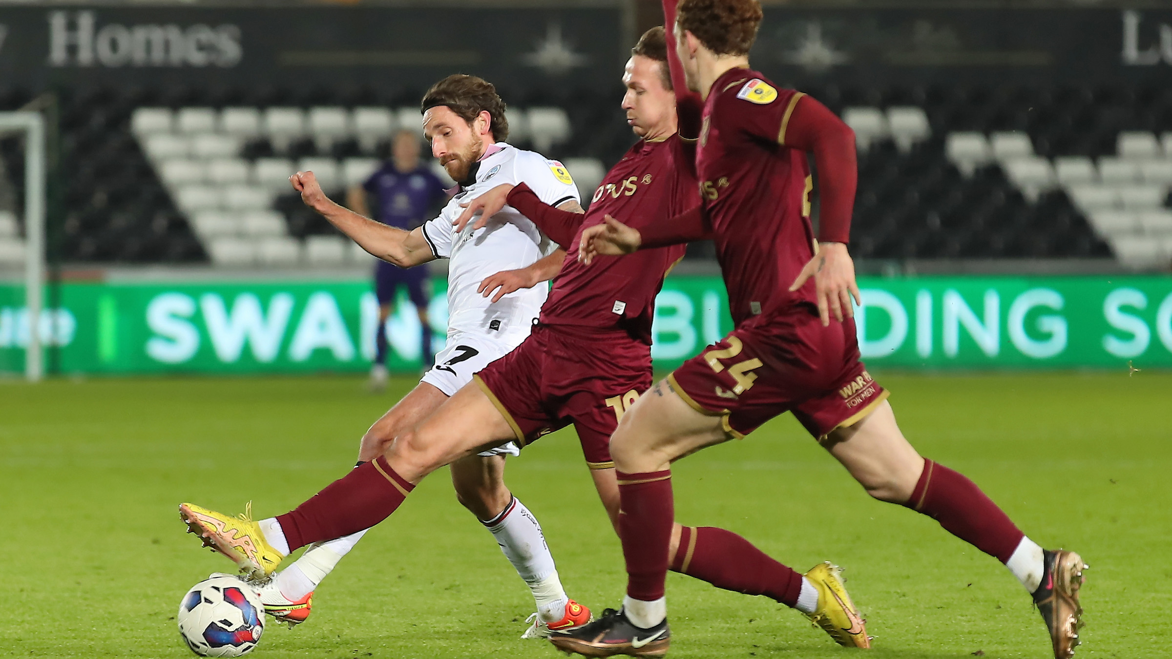 Joe Allen holds off two Norwich City players