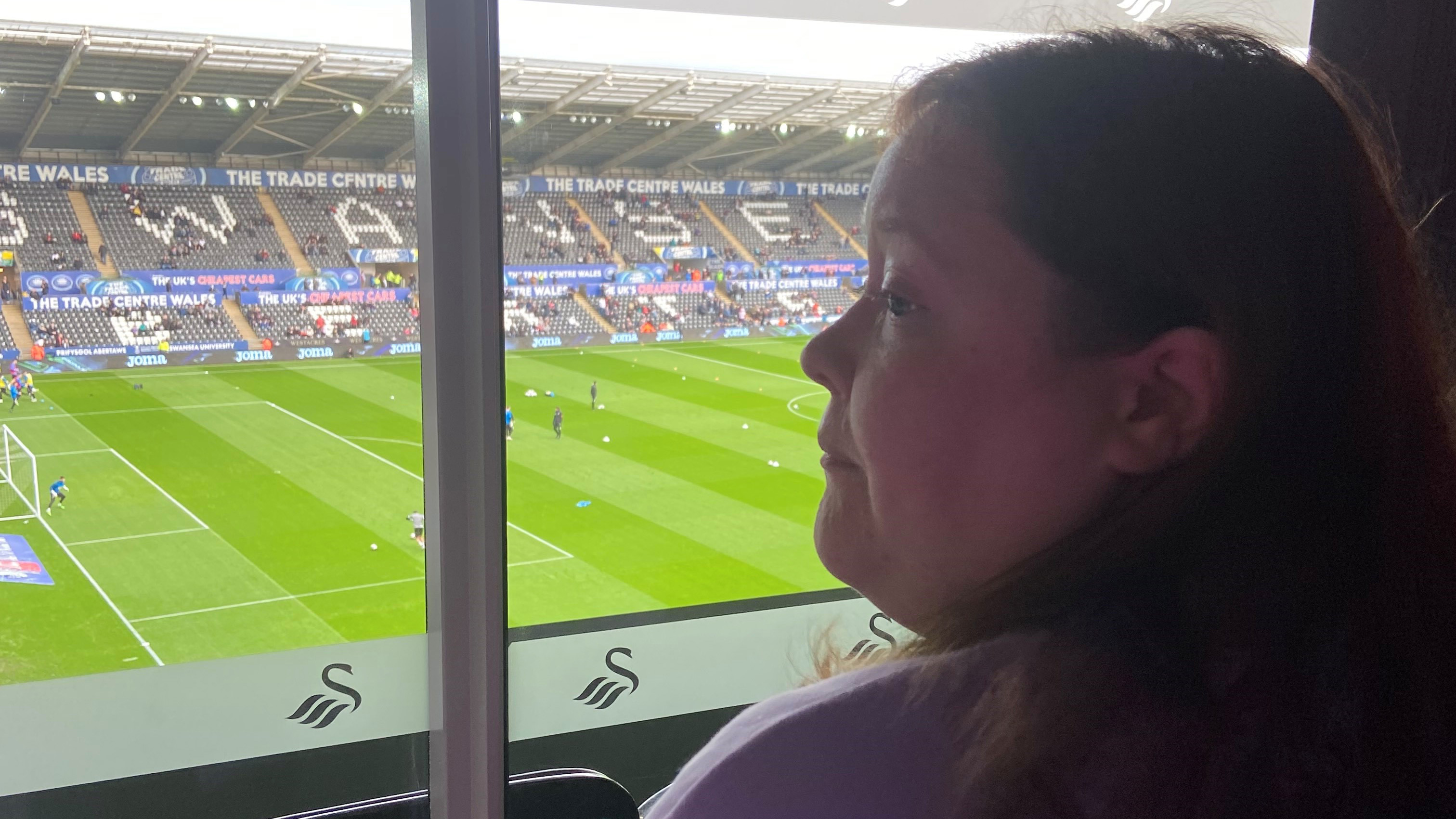 Nicola watches the Swansea City match through the glass in the sensory room