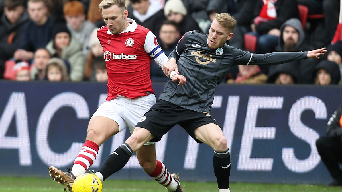 Ollie Cooper battles for the ball against Bristol City