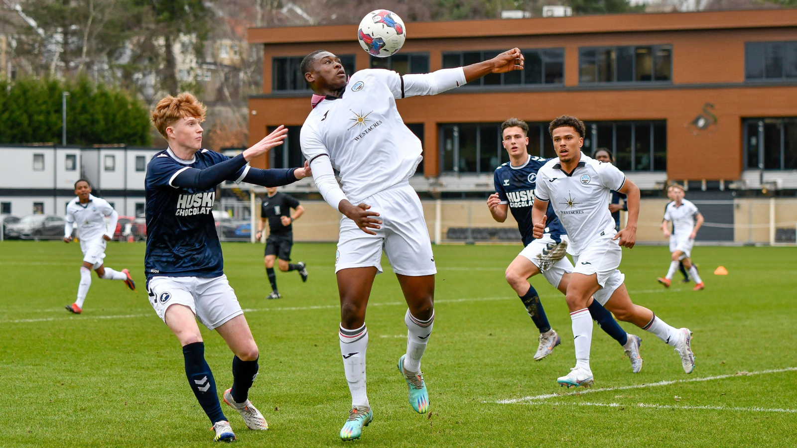 Swansea, Wales. 4 February 2023. Richard Faakye of Swansea City holds off  the challenge from Jack Howland of Millwall during the Professional  Development League game between Swansea City Under 18 and Millwall