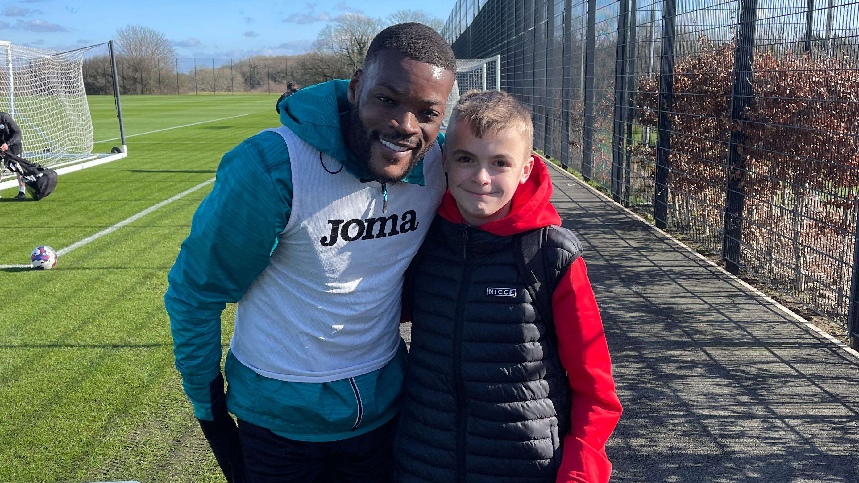 Swans fan Alfie poses with Olivier Ntcham