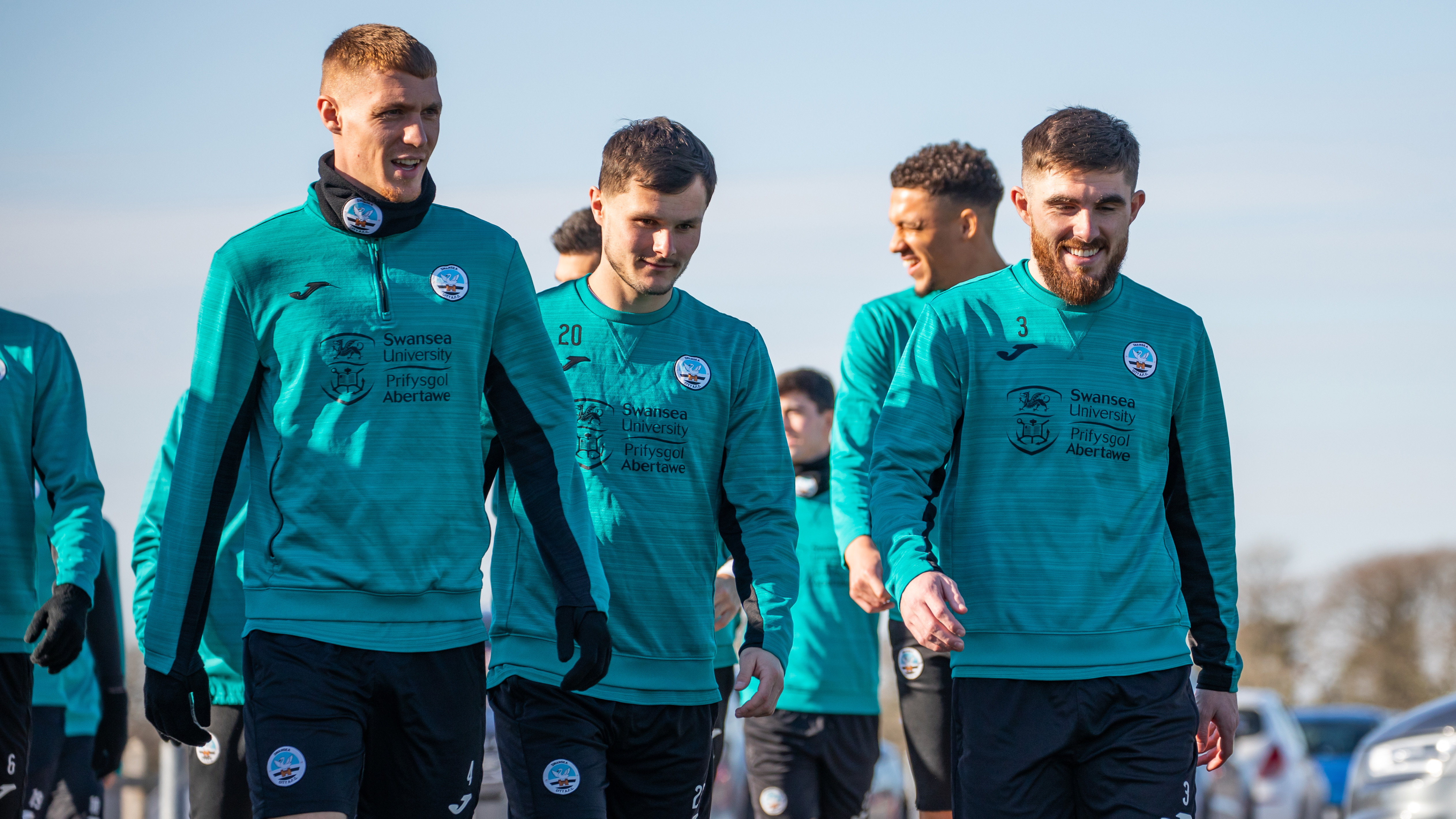 Jay Fulton, Liam Cullen, and Ryan Manning talking as they walk to training