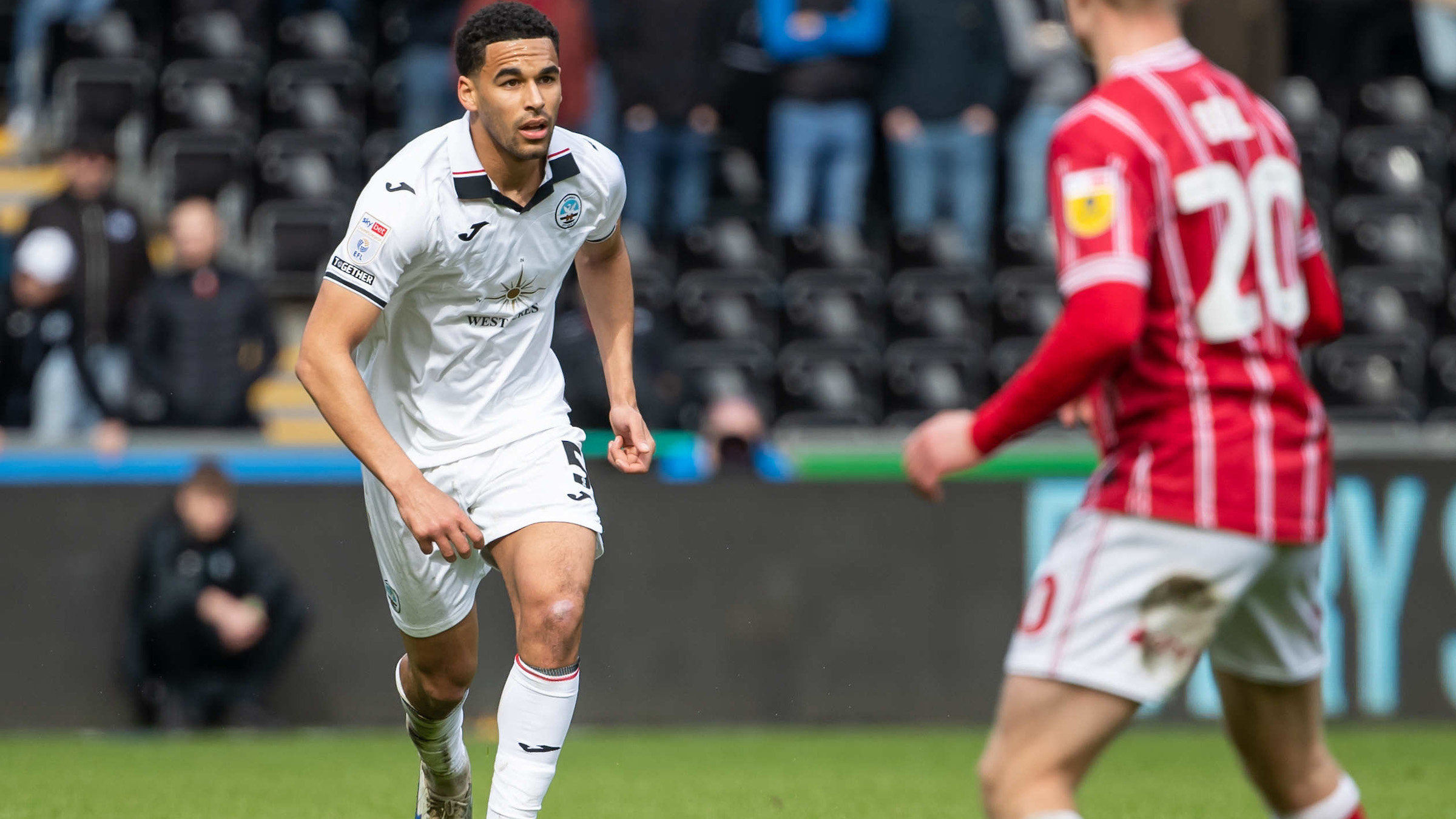 Ben Cabango runs with the ball against Bristol City