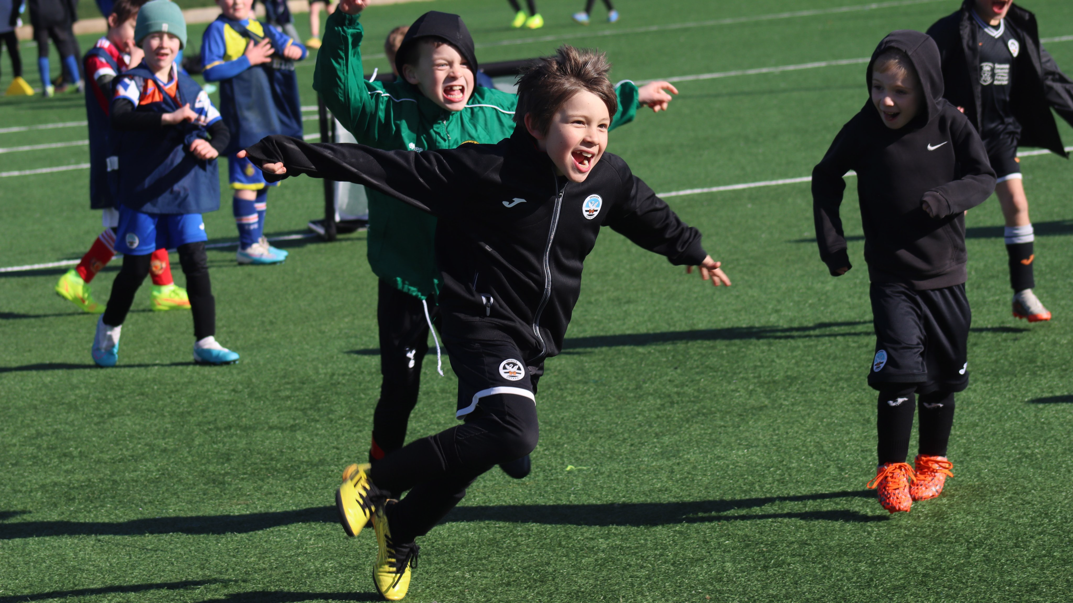 Children playing football at soccer camps