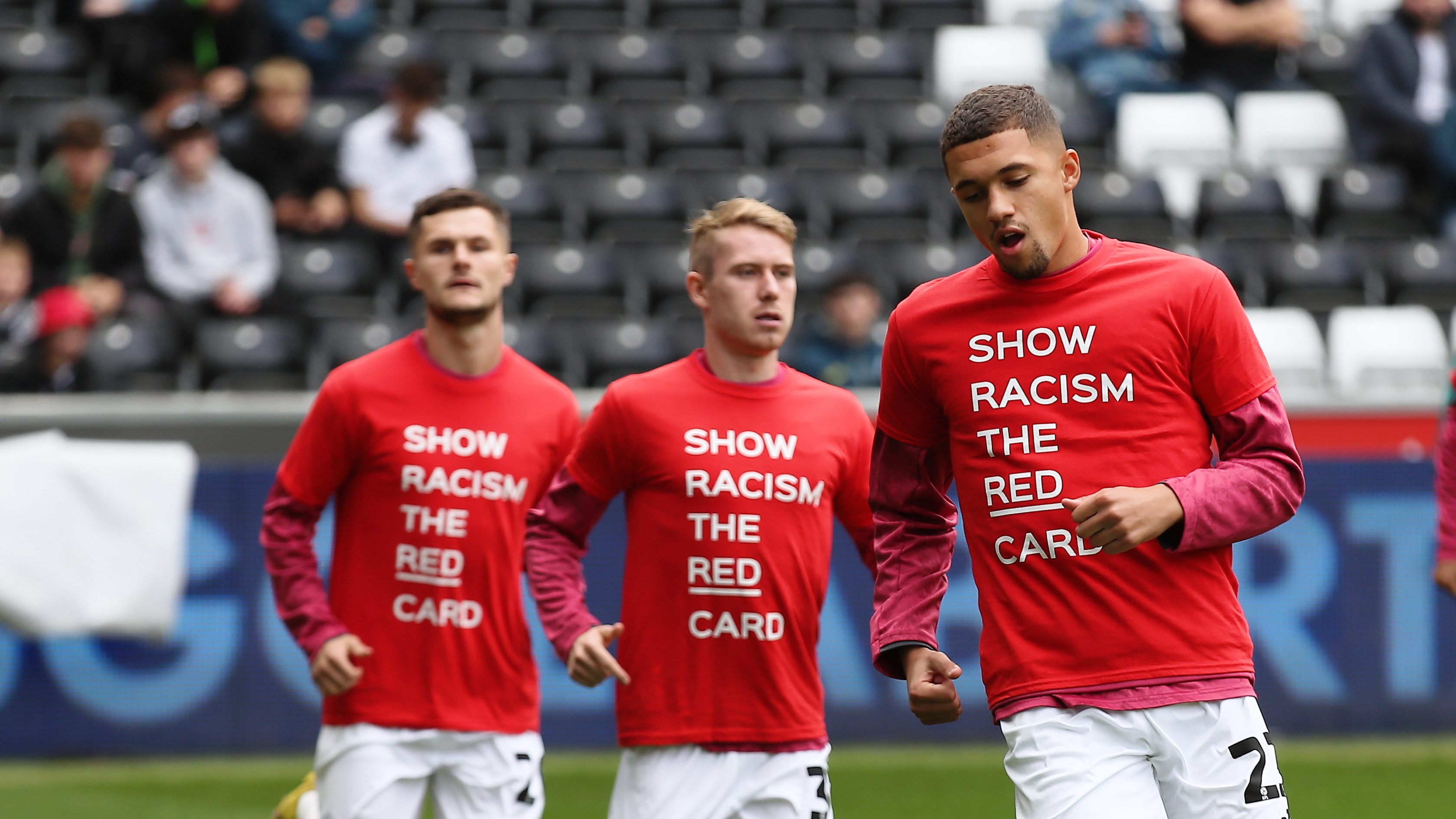 Swansea City players warm up in Show Racism the Red Card t-shirts