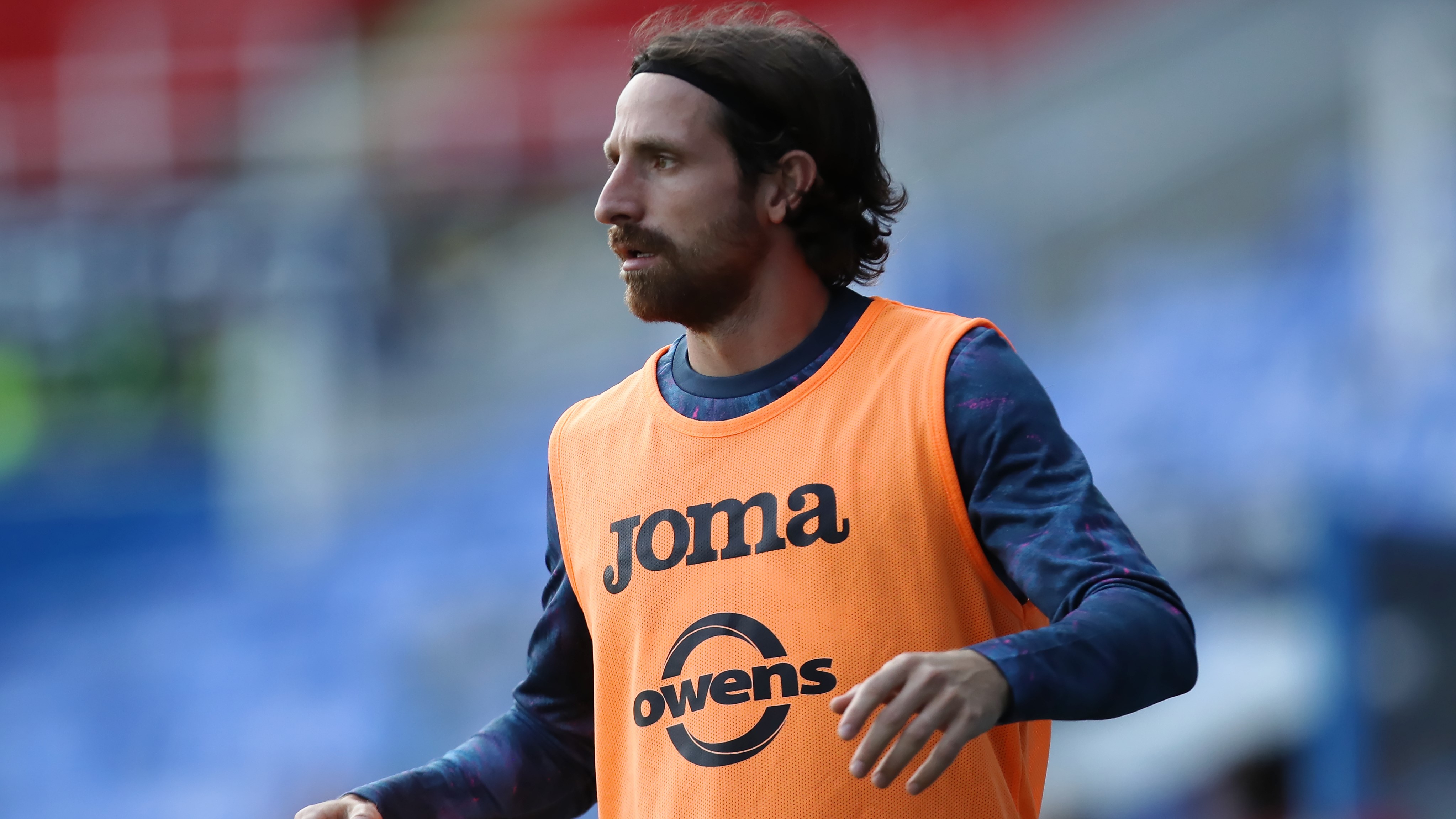 Joe Allen warms up as a substitute