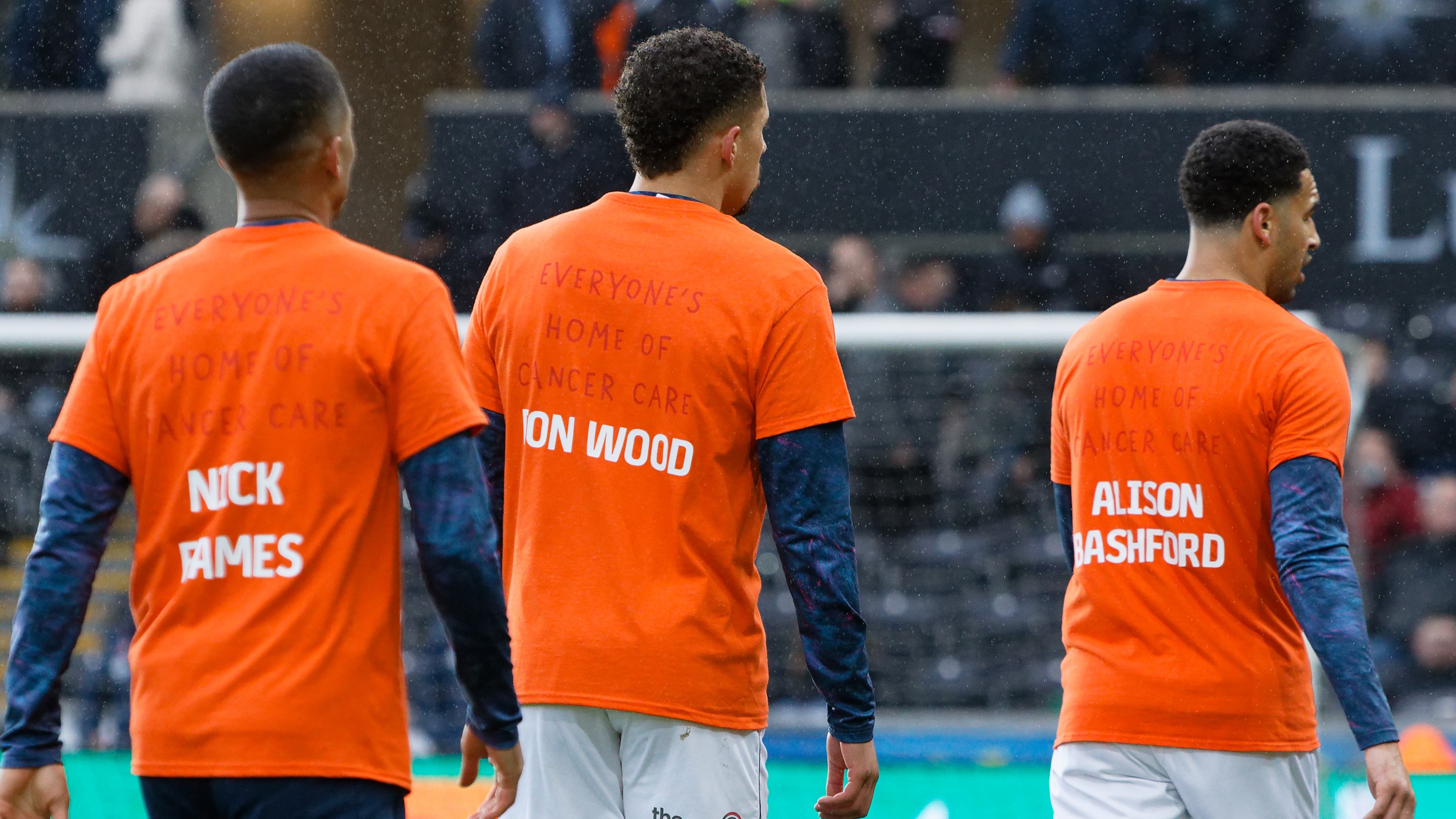 Players warm up in Maggie's Warm up shirts with names of loved ones on the back