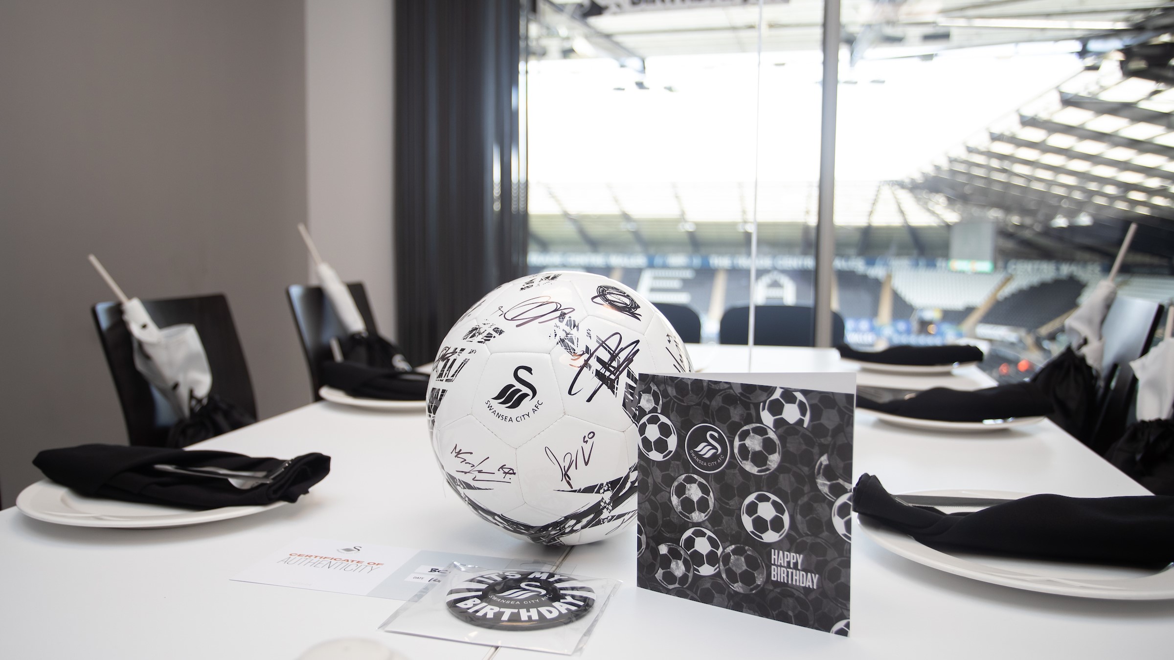 Image of hospitality box with birthday card, signed ball and set up for the birthday box bash