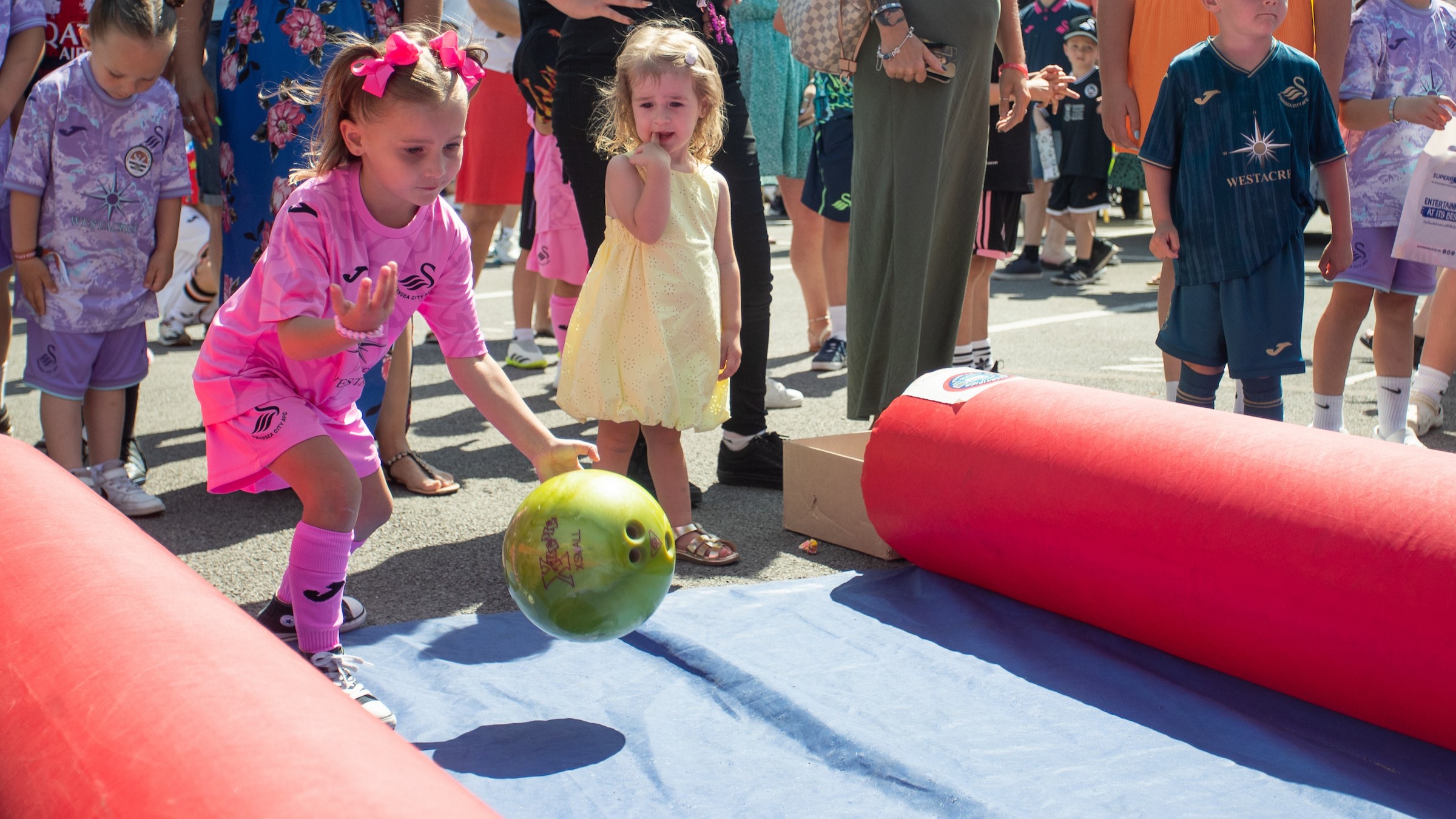 Young fans bowling in the fan park