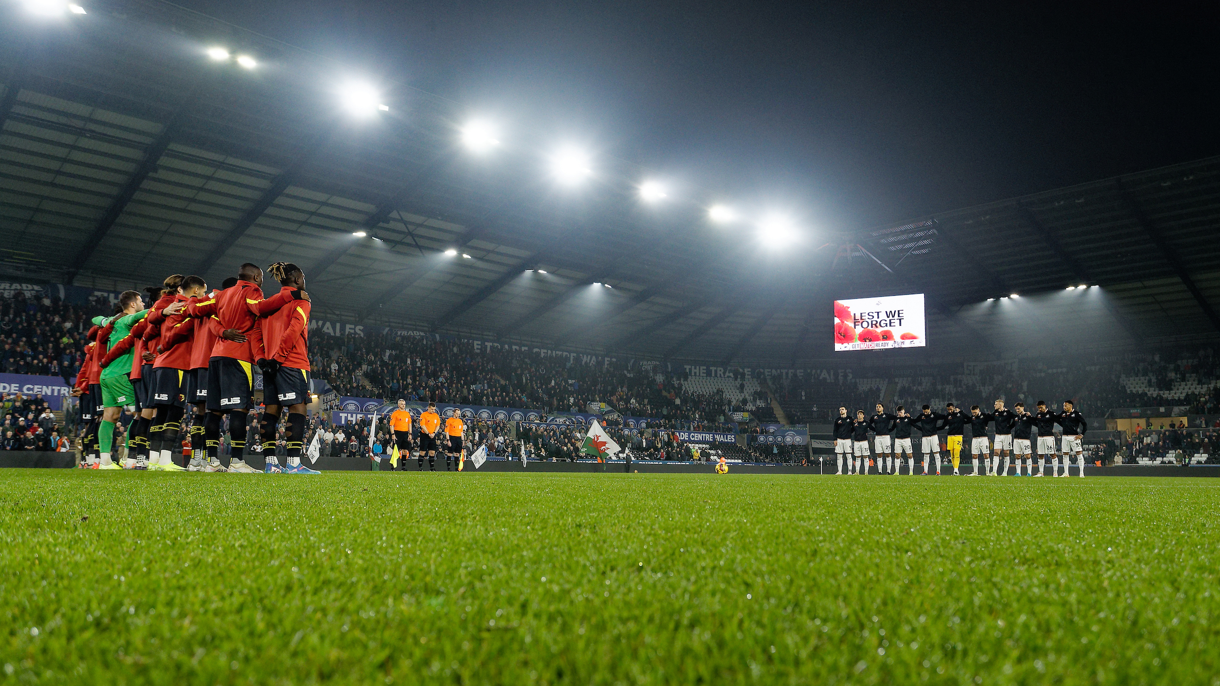 The teams line up during a Remembrance service