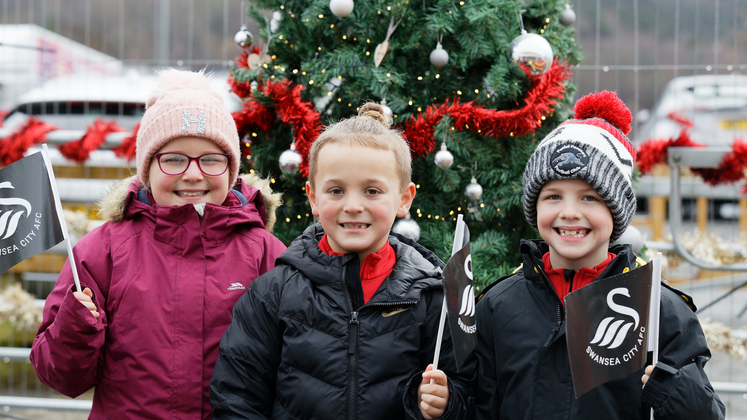 Junior Jacks stand in front of the Christmas tree at the fan park