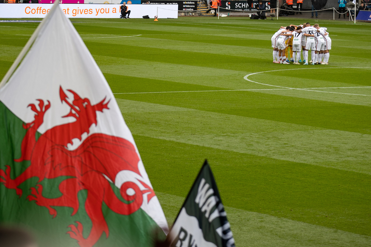 Swansea City players huddle at the Swansea.com Stadium