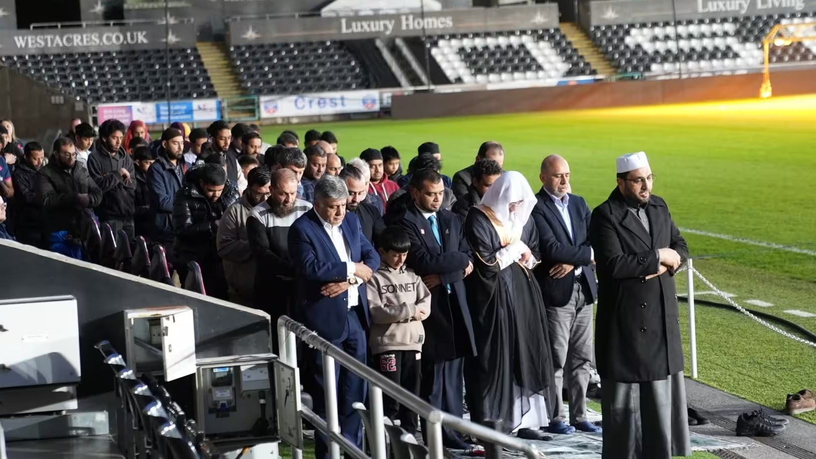 People pray pitchside