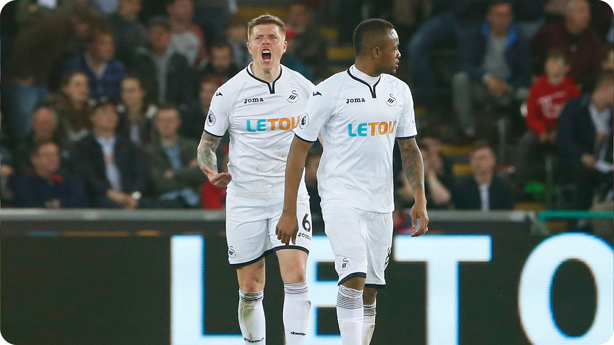 Alfie Mawson encouraging the fans