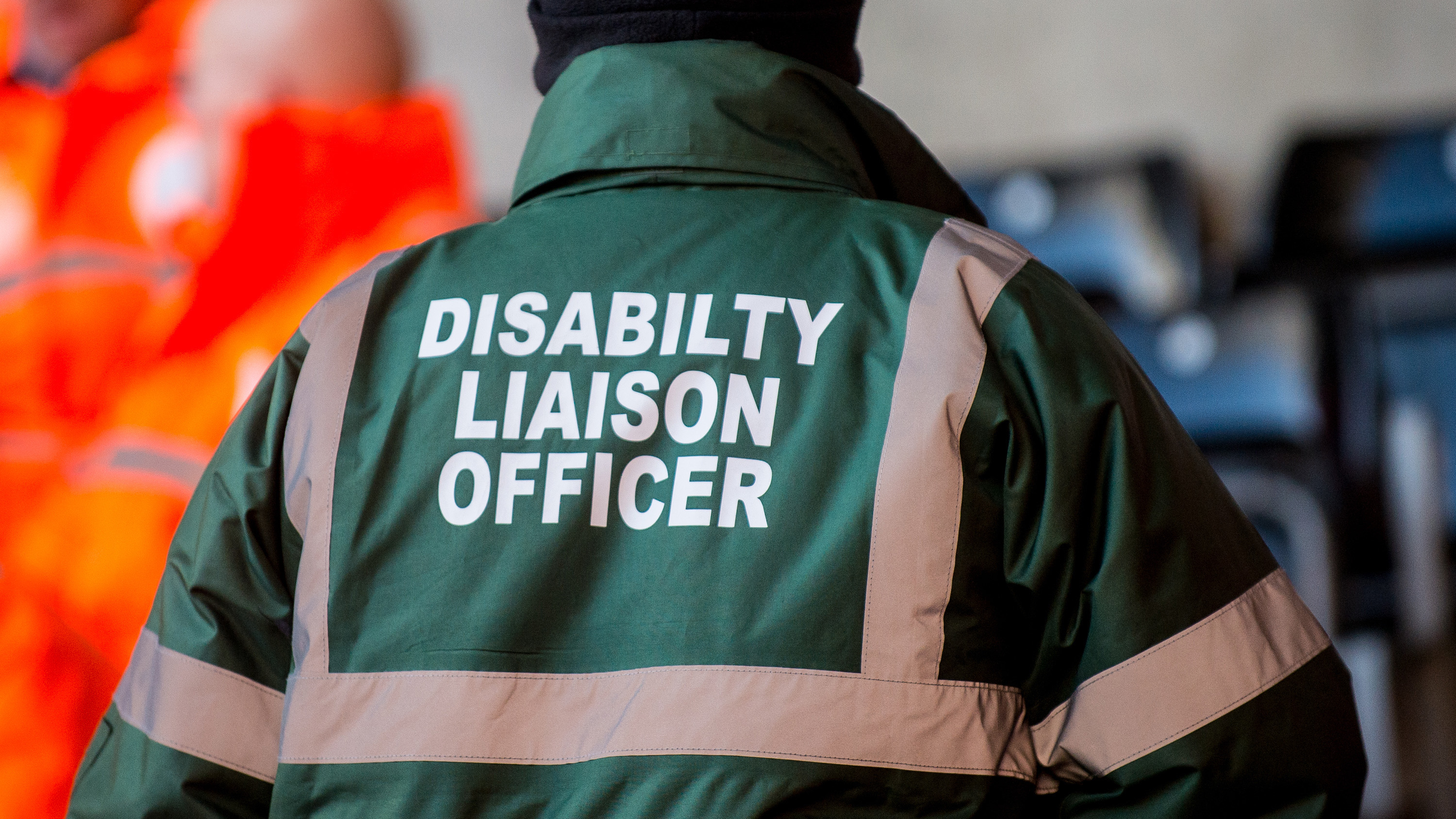 image of the back of a green disability liason officer's jacket